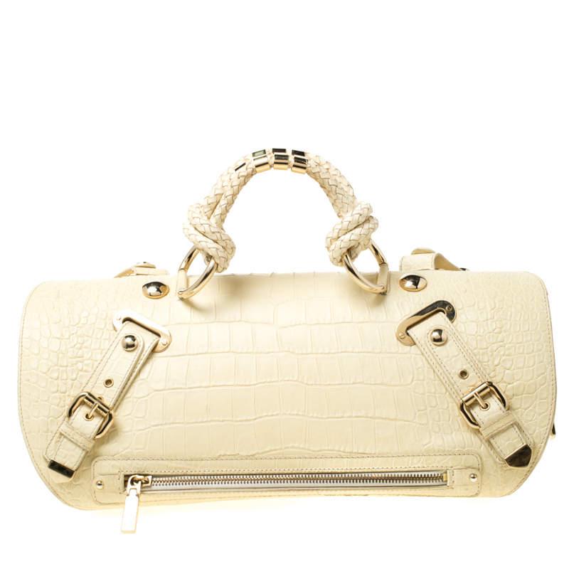 Designed in a unique and wonderful silhouette, this Canyon bag from Versace will be a special addition for any closet. It is crafted from croc-embossed leather and suede and is accented with buckled straps on the exterior along with the signature