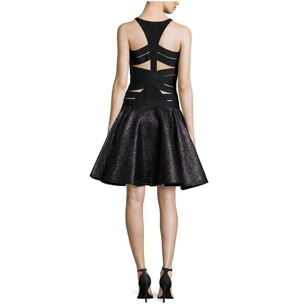 Sheer mesh stripes and insets lend a daring element to this sexy Versace cocktail dress. 
Sleek, raffia inspired stitches shimmer throughout the swingy skirt. 
Slim halter neckline and modern racer back. 
Chiffon lining. Fabric: ponte jersey / faux