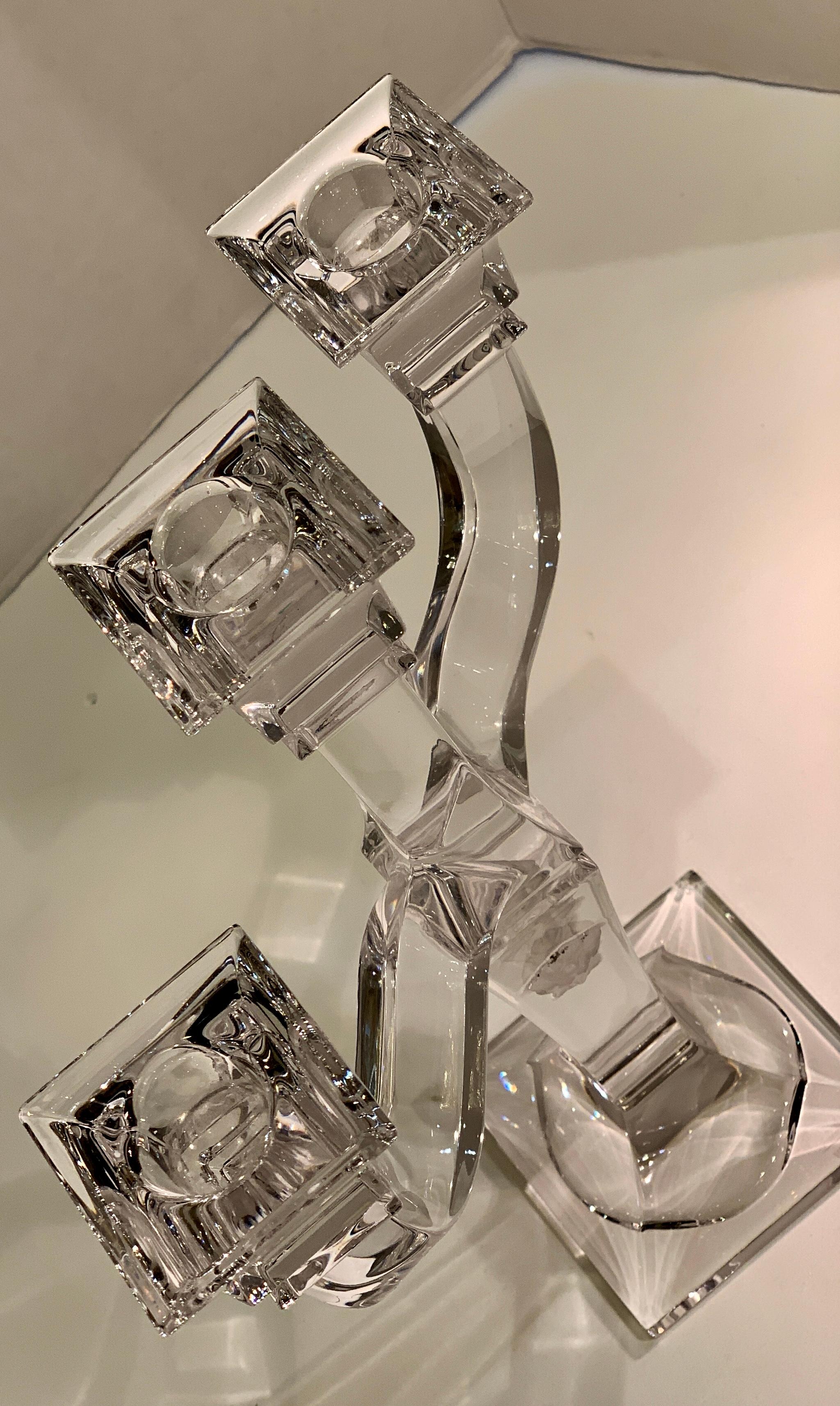 Elegant Versace by Rosenthal three branch candelabra is a solid, clear lead crystal candle holder, featuring two frosted crystal Medusa face medallions on the stem, a square base and square boboches.

Measures 12