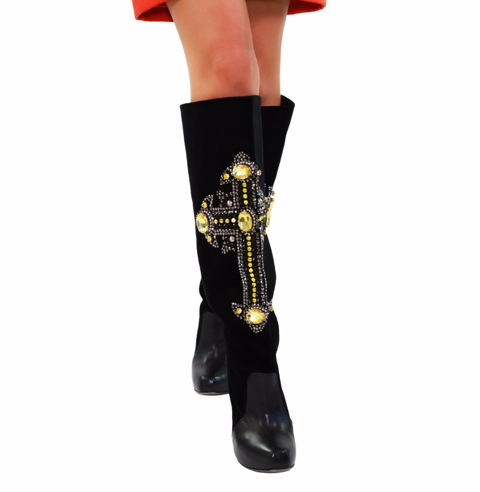 VERSACE

Crystal-embellished velvet and leather knee boots

Crystal and bead-embellished leather cross appliqué, leather panel at front, square toe

Geometric block heel measures approximately 115mm/ 4.5 inches with a 25mm/ 1 inch concealed