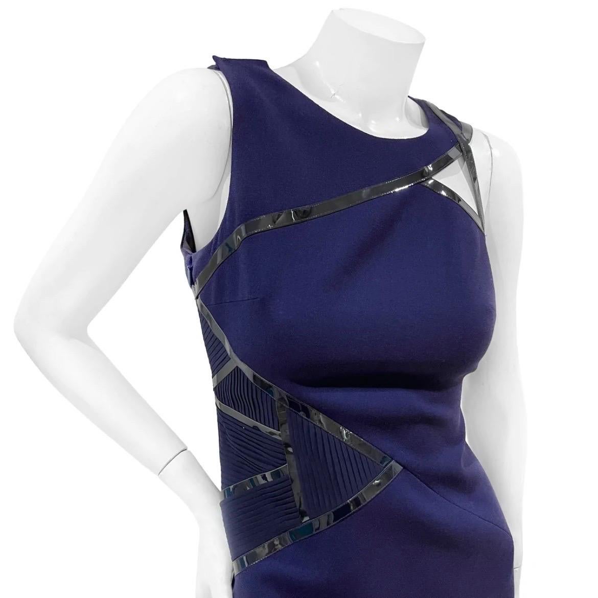 Purple Cut-Out Asymmetrical Dress by Versace
Fall / Winter 2010
Made in Italy
Dark purple
Asymmetrical cut out detail on front and back of dress
Pleated geometric fabric detail on side of dress
Black strip lining 
Top shoulder sleeve has clasp