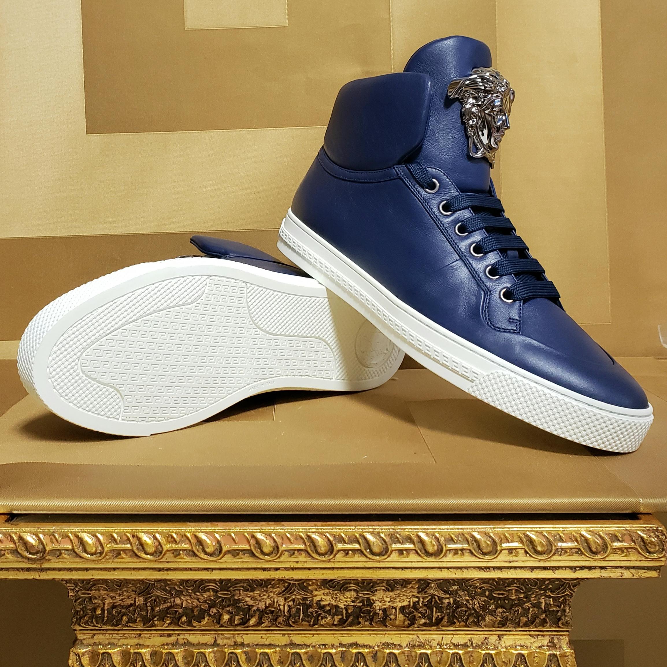 VERSACE 

Palazzo sneakers 

This shoe is embodied in true Versace-style and

 features blue leather with gold iconic Medusa. It wouldn’t be Versace without it.

Made in Italy

Italian size is 39 - US 6 
insole: 10 1/2