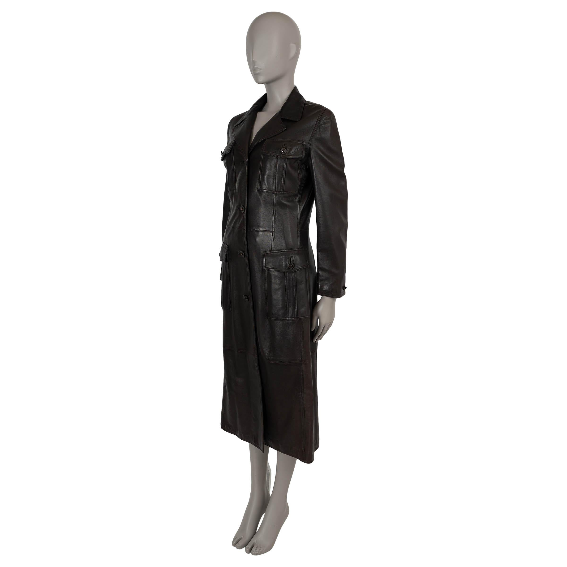 This 100% authentic vintage Gianni Versace midi coat is crafted from dark brown smooth lambskin leather, offering a timeless and luxurious look. The design features four front flap pockets, a classic notch lapel, and beautifully embellished buttons