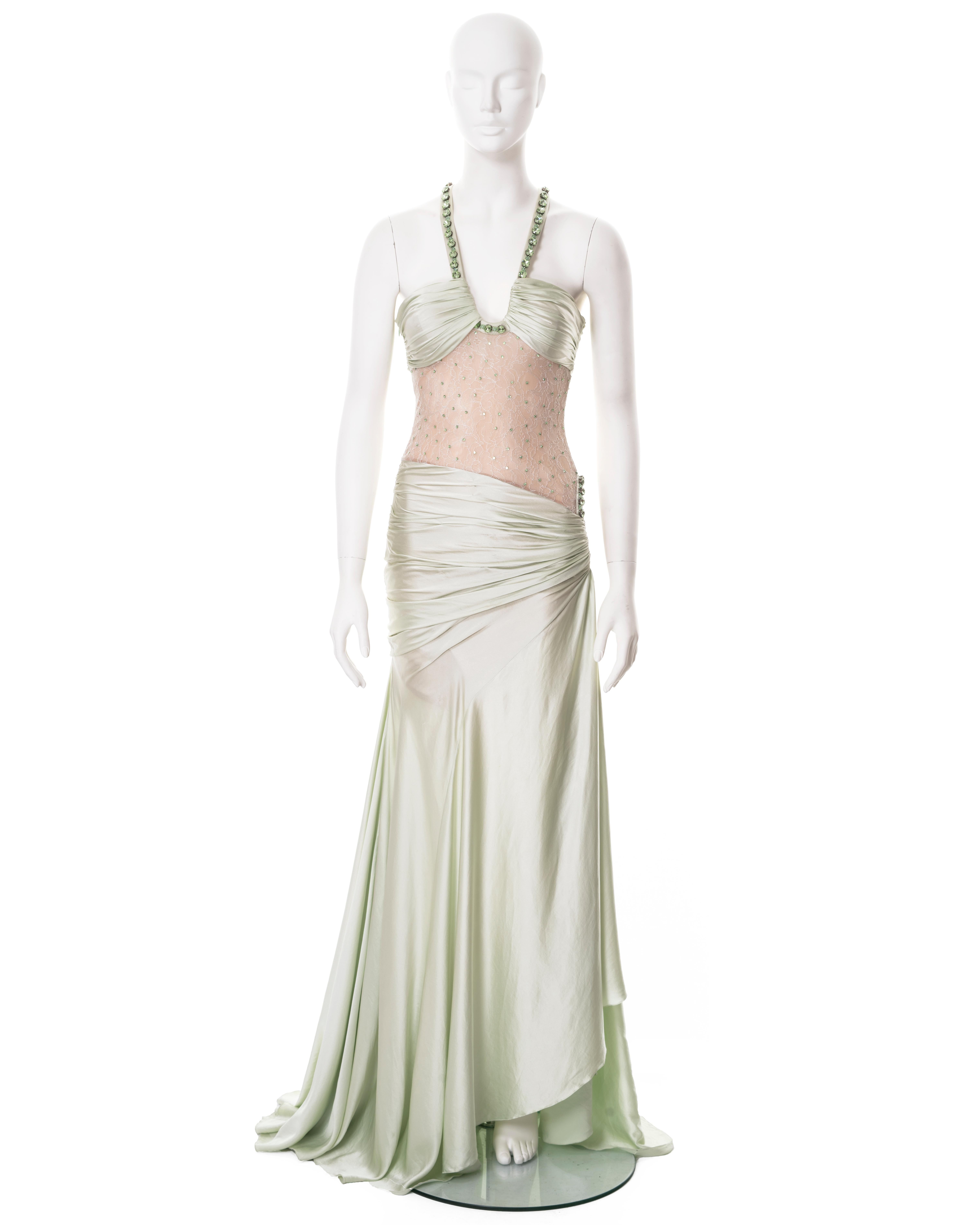 ▪ Versace demi-couture evening dress 
▪ Creative Director: Donatella Versace
▪ Sold by One of a Kind Archive
▪ Spring-Summer 2004
▪ Constructed from soft green silk 
▪ Large Swarovski cushion-cut crystals adorn the shoulder and hip straps
▪ Ruching