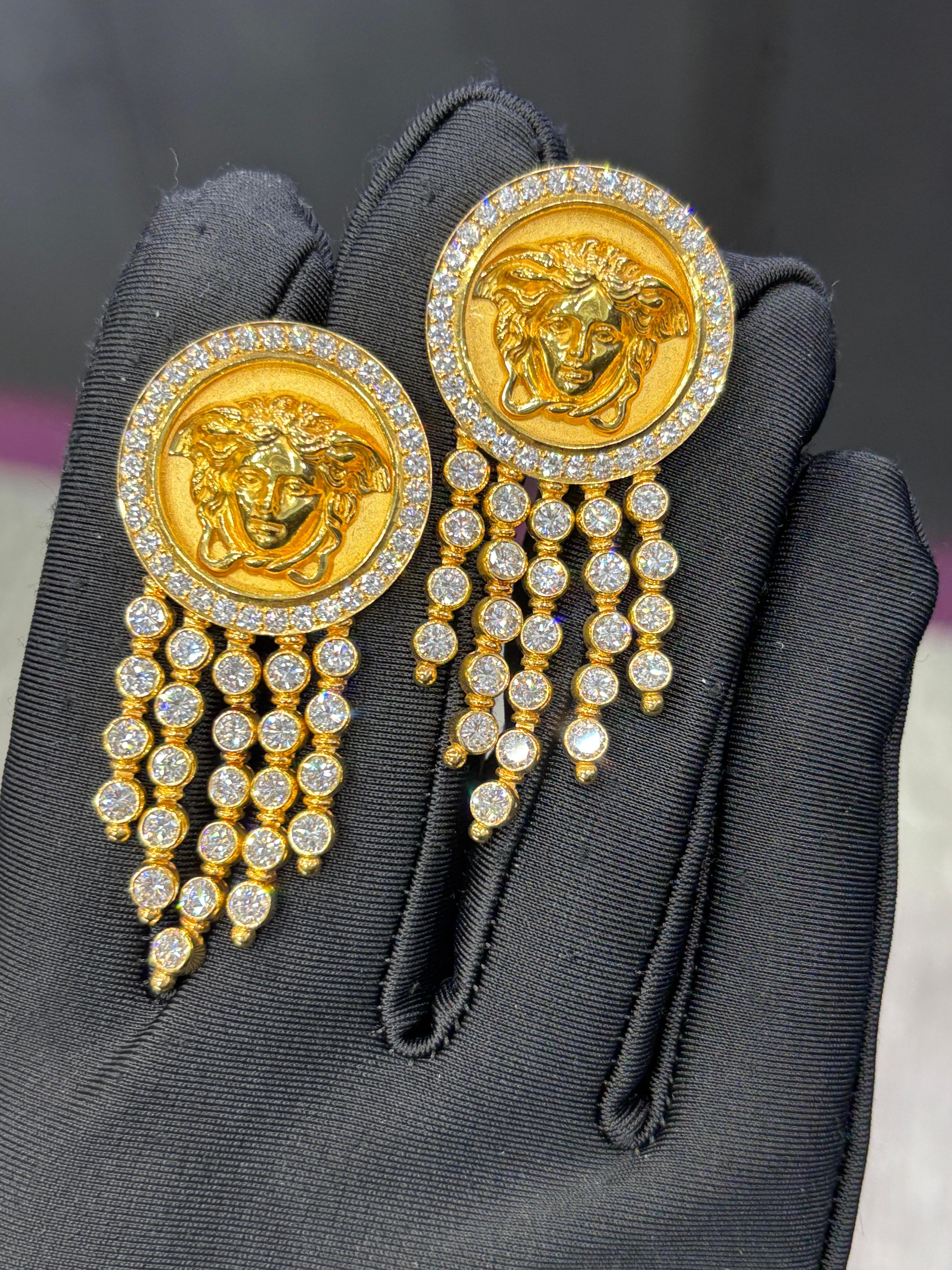Versace Diamond Earrings

A pair of yellow gold Versace earrings featuring the iconic Medusa motif, accented with round-cut diamonds and five rows of dangling diamonds.

Approximate Length: 2 inches
Signed: Gianni Versace and numbered
Metal Type: 18
