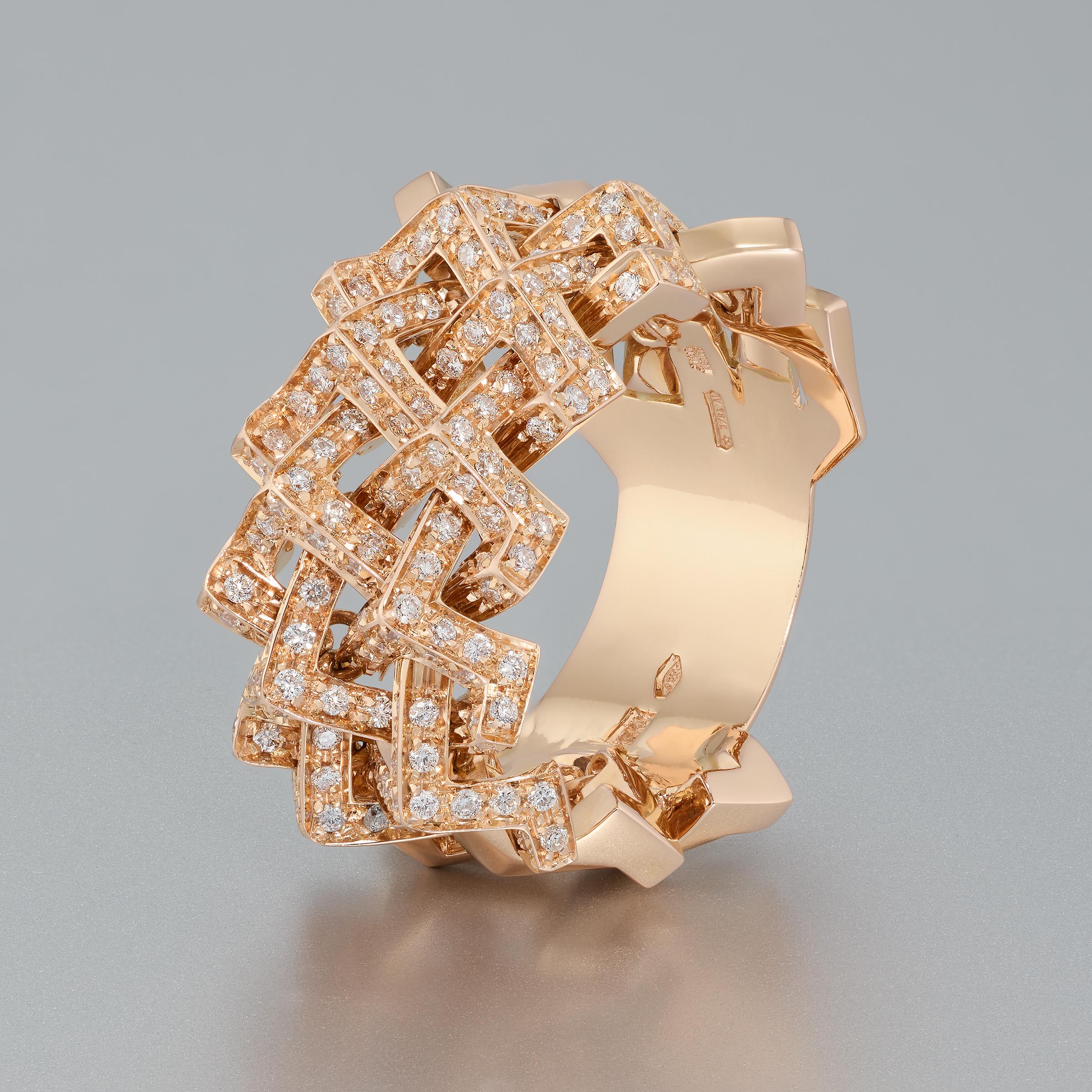 Fabulous Versace wide band ring is set with fine white round diamonds in shimmering 18 karat rose gold. This ring is bold and modern but also, as typical of most Versace creations, it finds its inspiration in ancient designs. The top section of the