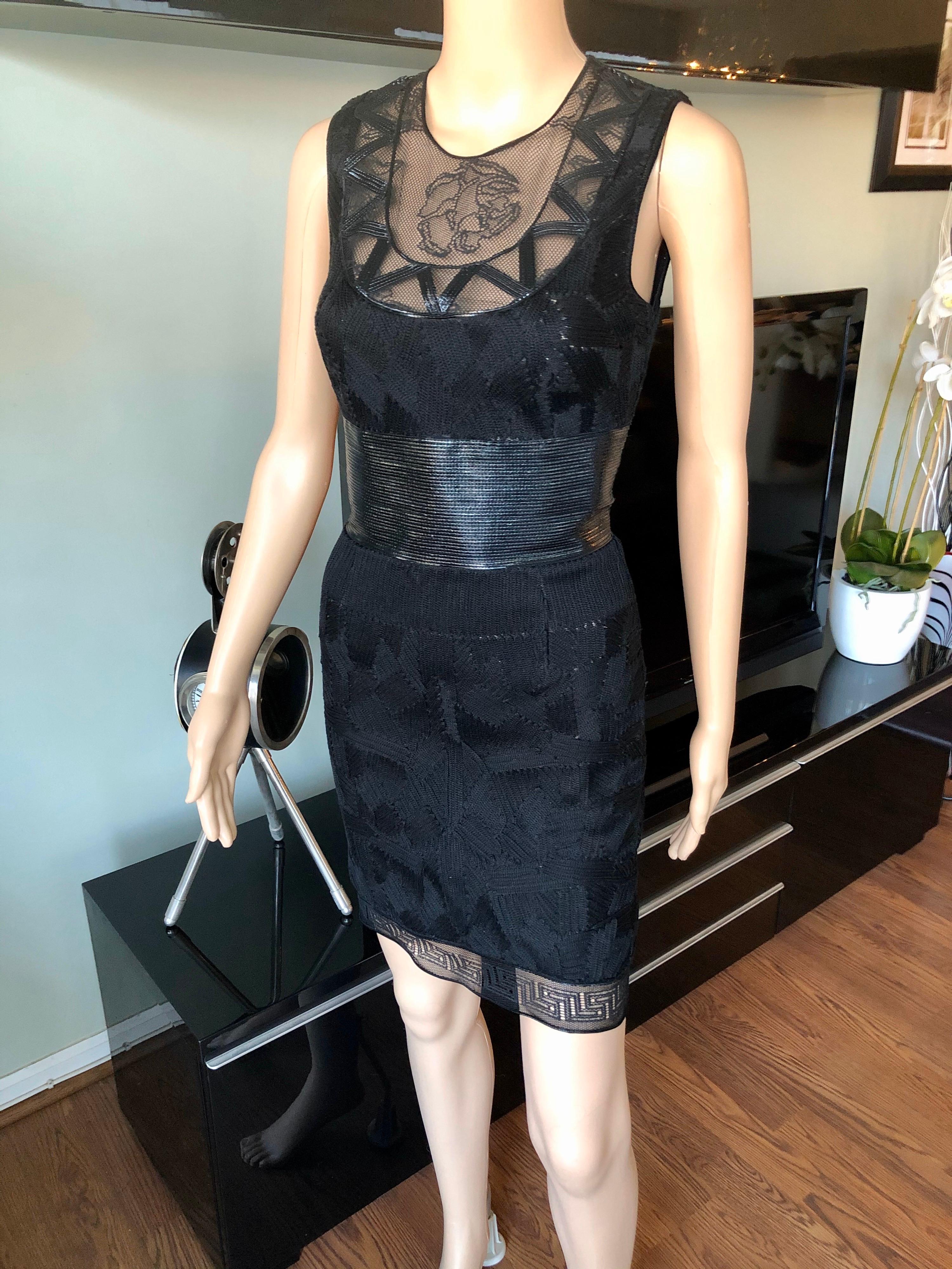 Versace Embroidered Sheer Mesh Panels Black Mini Dress IT 40

Versace black mini dress featuring tonal mesh accents and embroidered texture throughout, crew neck, concealed zip closure at back and hook-and-eye closure at nape.
 