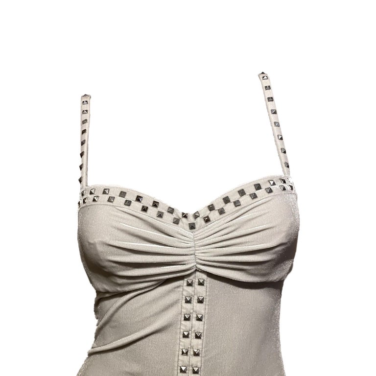 Versace grey velvet bodycon dress with form-fitting ruches from Donatella Versace’s Fall/Winter 2004 “Punk” collection (worn by Caroline Winberg). Embellished with silver studs all over, new with tags.

Size 42

Total length: 104 cm/40.9 inch
Bust: