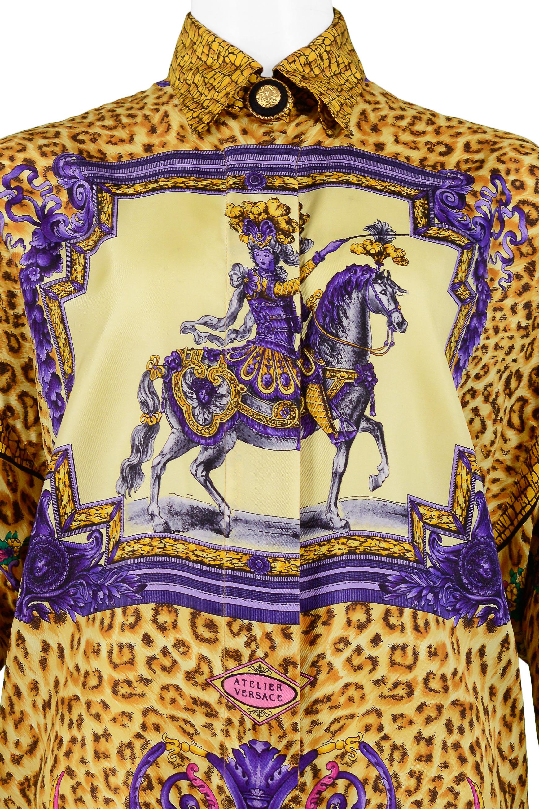 Resurrection is excited to offer a vintage Gianni Versace Couture silk oversized scarf blouse featuring a flap collar, decorative black and gold Medusa buttons, a front placket with hidden buttons, long sleeves, contrasting border print, and an