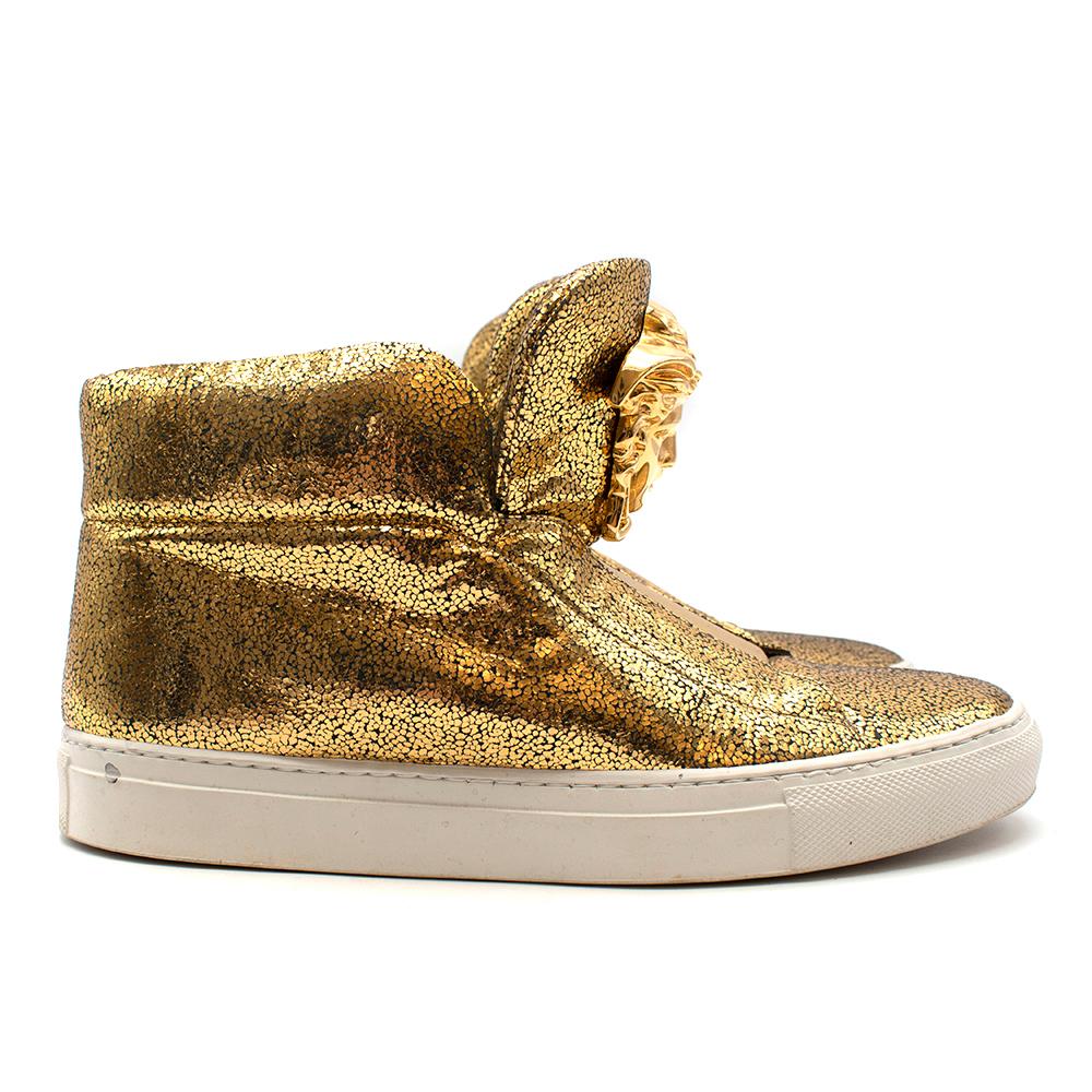 Versace Gold Leather High-Top Palazzo Sneakers 

- Signature Palazzo style high-tops 
- Gold speckled leather 
- Gold Medusa emblem on shoe tongue
- White rubber sole 
- Elastic front panels
- Slip-on style 
- EU 38/ UK 5

Materials: 
Main - 100%