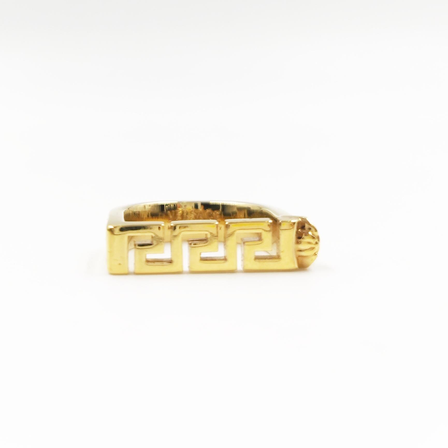 Elevate your style with the Versace Gold Greca Bar Women's Ring, a dazzling piece that combines modern elegance with iconic Versace design. This exquisite ring, brand new in its original box, is a true statement of luxury and sophistication.

The