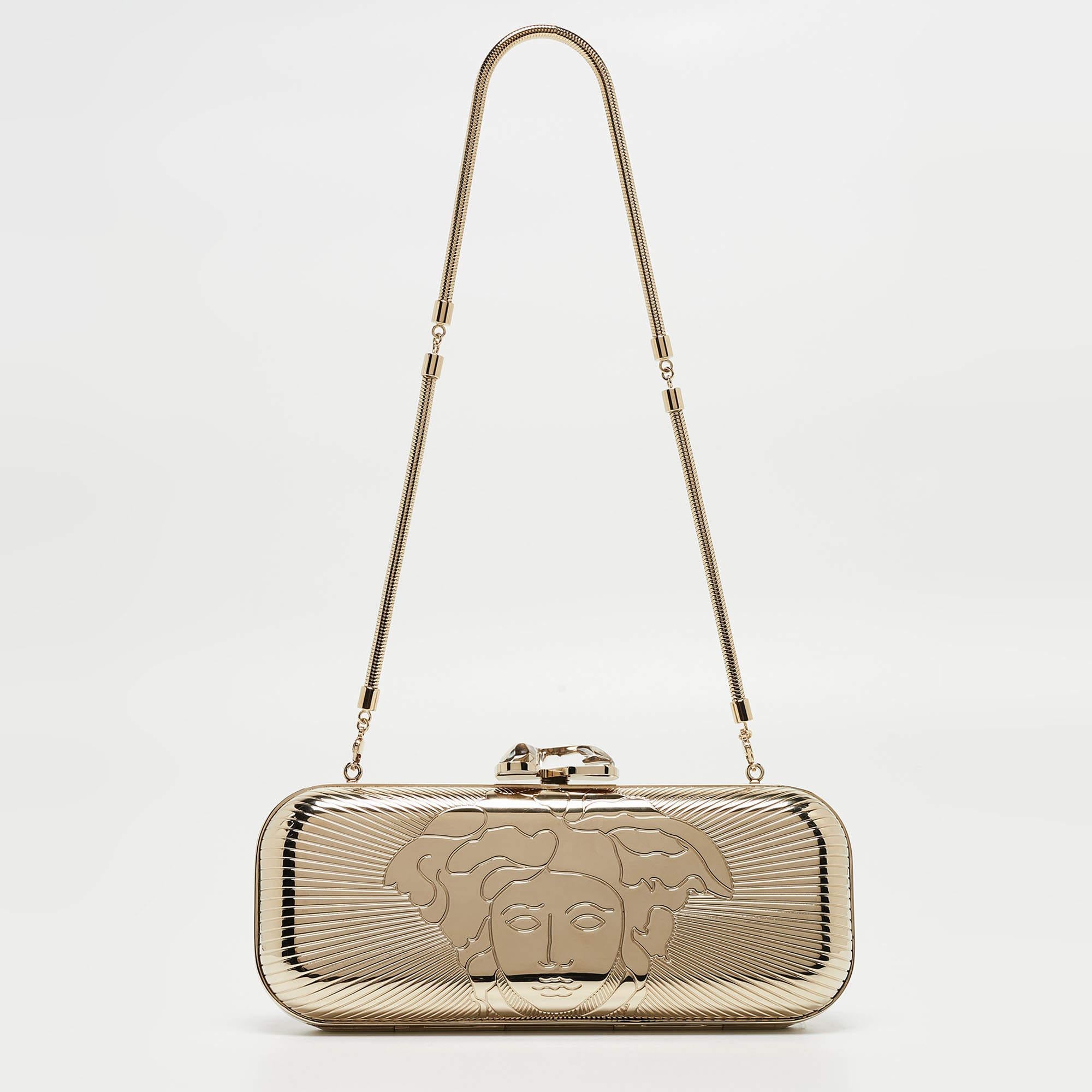 From the house of Versace comes this gorgeous clutch that will perfectly complement all your evening outfits. It has been crafted from gold metal and styled with a Medusa emblem that opens to a suede interior. This clutch wins with its structured