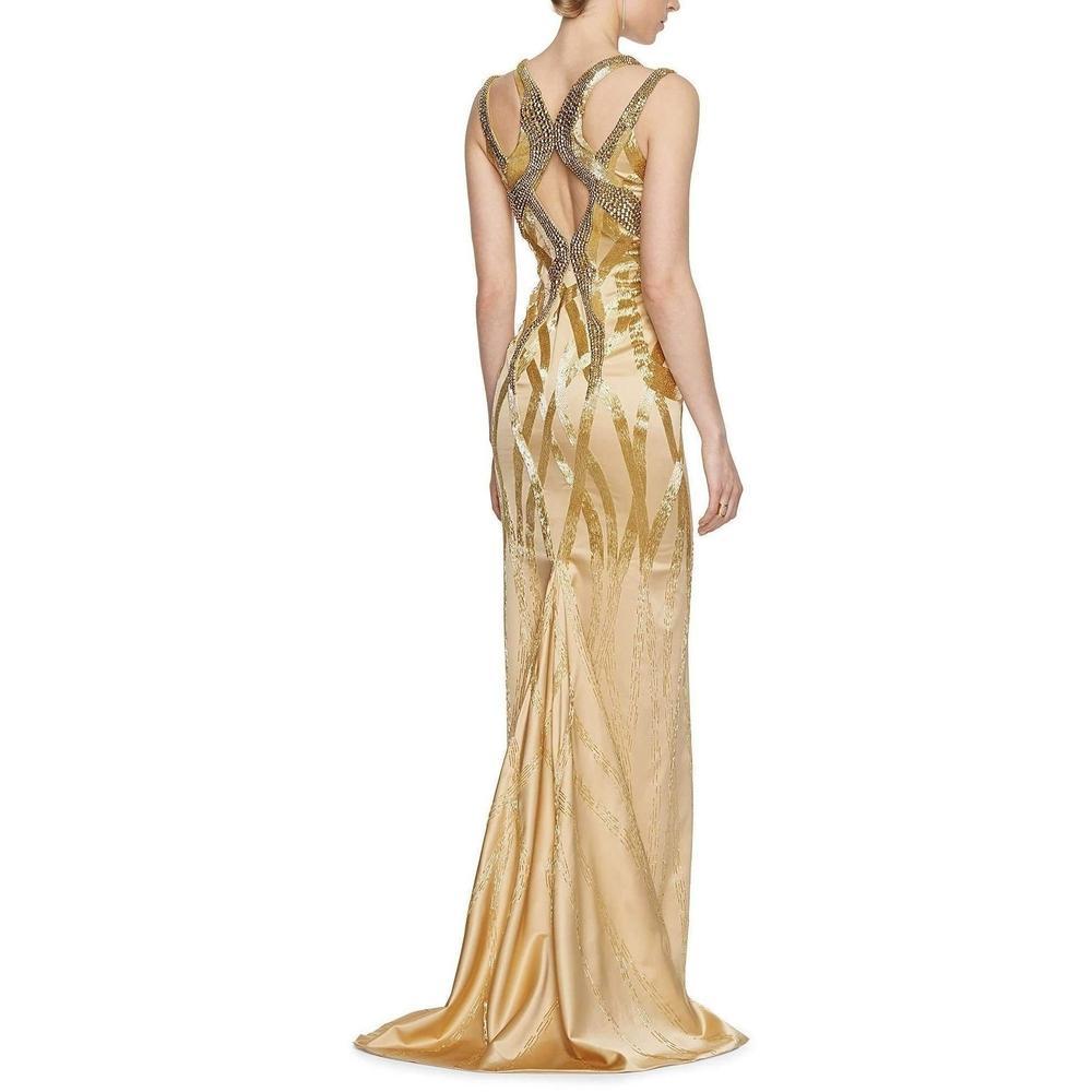 The Versace fashion house captures luxury, splendor and glamour in a collection piece worthy of your most special occasions. Faceted stones set off the dazzling bodice of this satiny silk dress, interlaced with thousands of sequins that delicately
