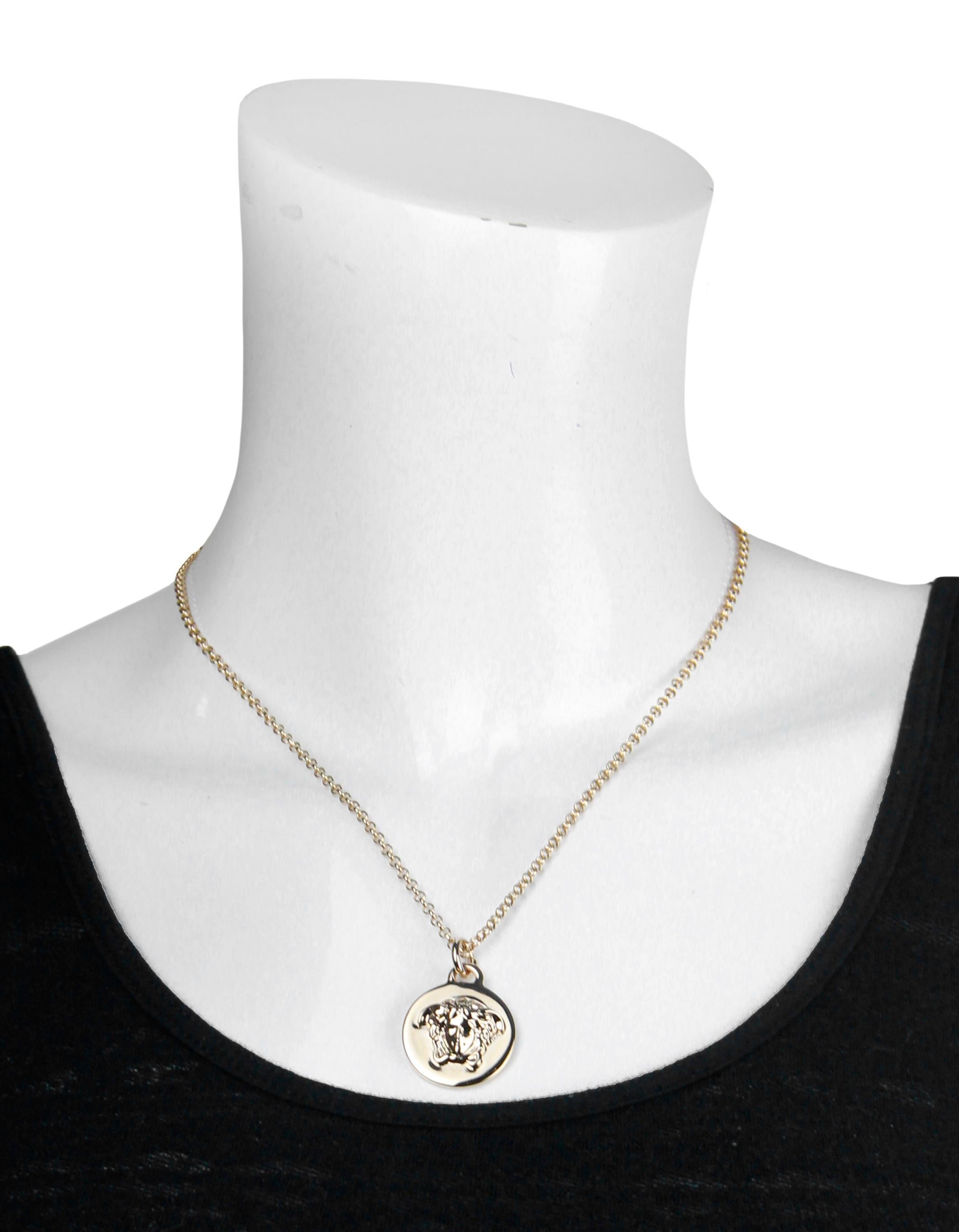 Versace NEW Goldtone Medusa Head Pendant Necklace
Materials: Goldtone metal
Hallmarks: VERSACE MADE IN ITALY
Oening: Lobster clasp with adjustable chain
Overall Condition: Excellent with very light surface scratching to back of pendant
Includes: