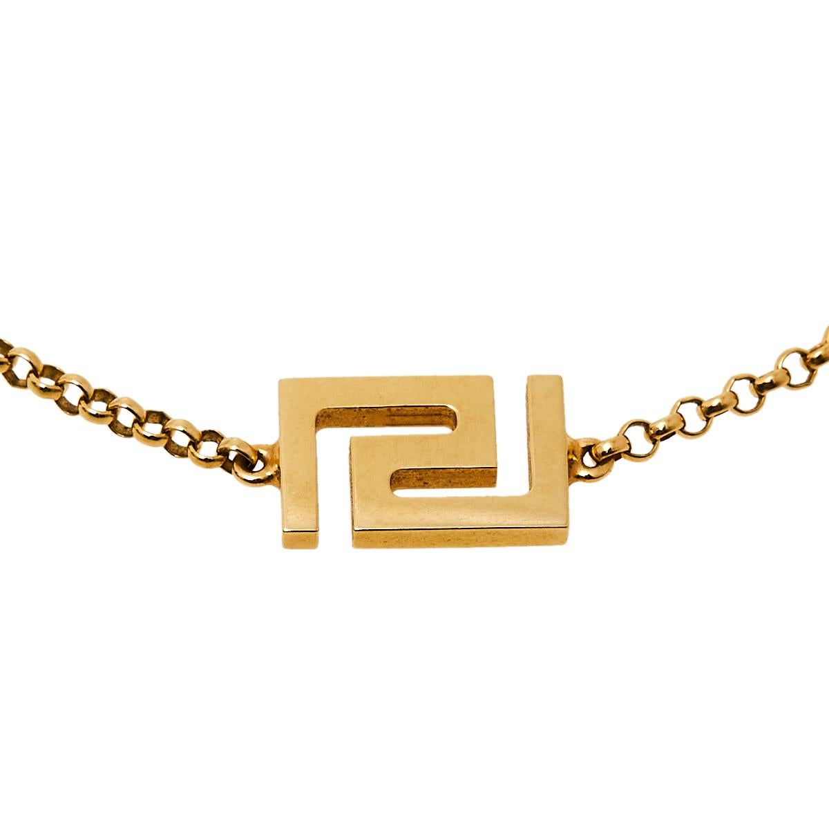 Artfully made from 18k yellow gold, this flawless bracelet by Versace can be your next prized possession. Featuring a gorgeous signature Greek key charm, the design has been finished with a lobster clasp on the chain. The piece is simple and