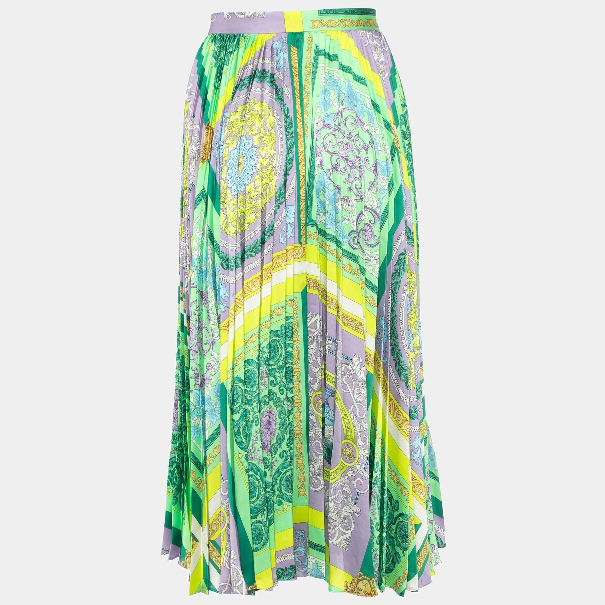 Indulge in the opulent allure of the Versace skirt. Crafted with meticulous detail, this luxurious piece features a mesmerizing mosaic print in vibrant green hues, complemented by elegant pleats, offering a sophisticated blend of style and allure.

