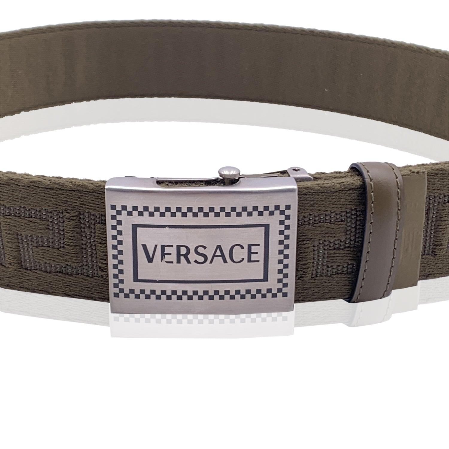 Military green unisex belt from Versace. Made from miltary green fabric, the belt features a Greek pattern, genuine leather trims and a silver metal signature logo buckle. Width: 1.5 inches - 4 cm. Size 80/32. Total length of the strap: 34.5 inches