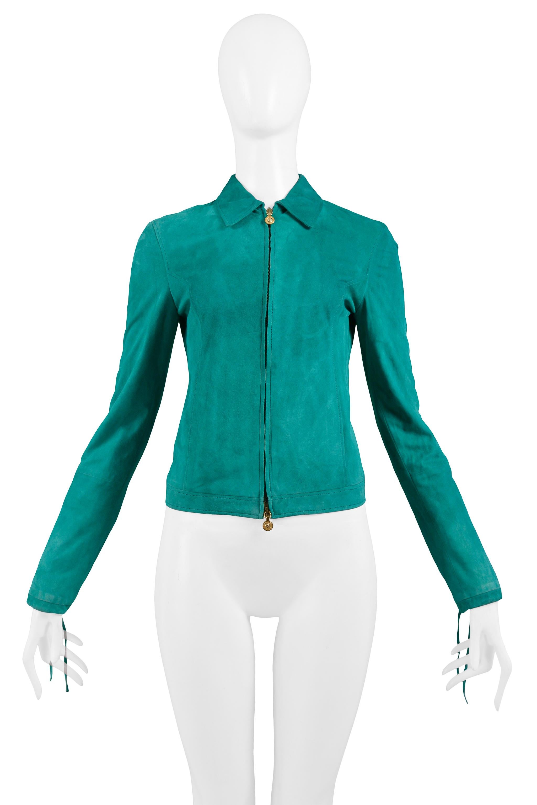 Resurrection Vintage is excited to offer a vintage Versace teal green suede jacket featuring a center front zipper with gold Medusa zipper pulls, and slits at lower sleeves with ties at cuffs.

Versace 
Measurements: Shoulder 13.5