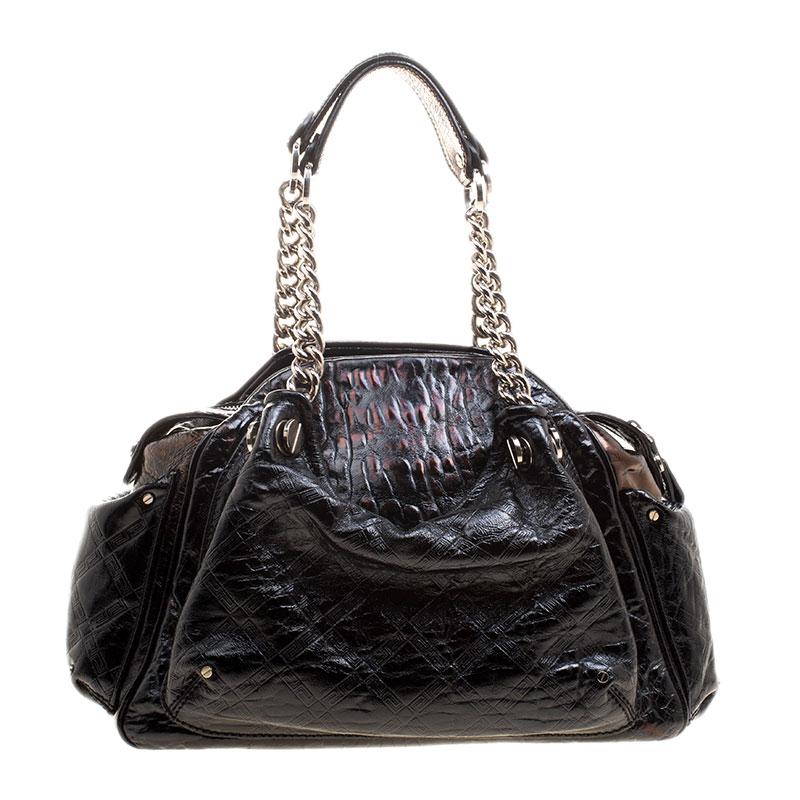 Crafted in black patent leather and accented with silver tone hardware details, this satchel from Versace is perfect for everyday and casual use to carry all your essentials with you. Featuring a quilted design on the surface and a V charm, this bag