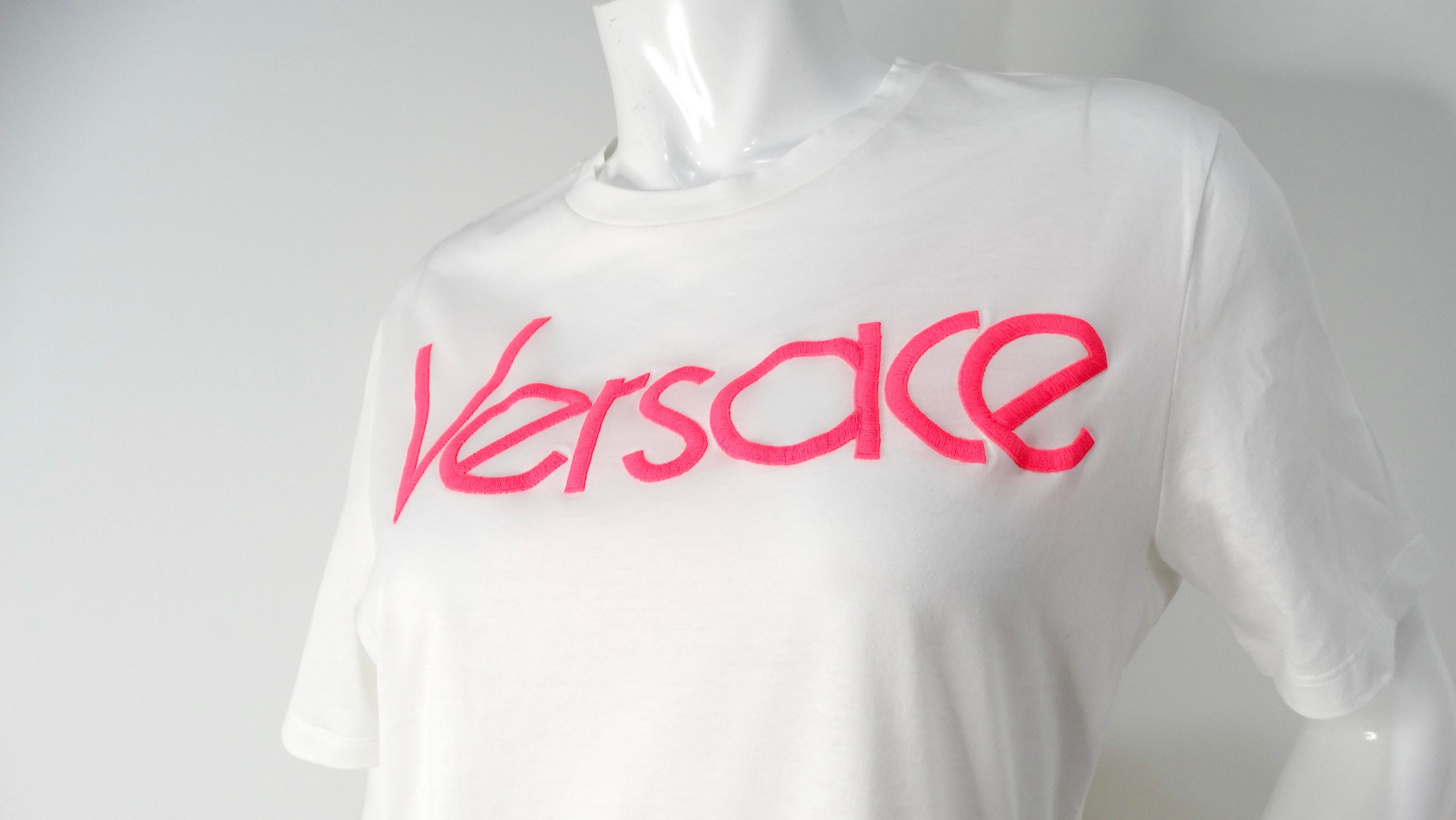 Elevate your casual wardrobe with the striking Versace Hot Pink Embroidered White Cotton T-Shirt. Crafted from soft, breathable cotton, this classic white tee features the iconic 