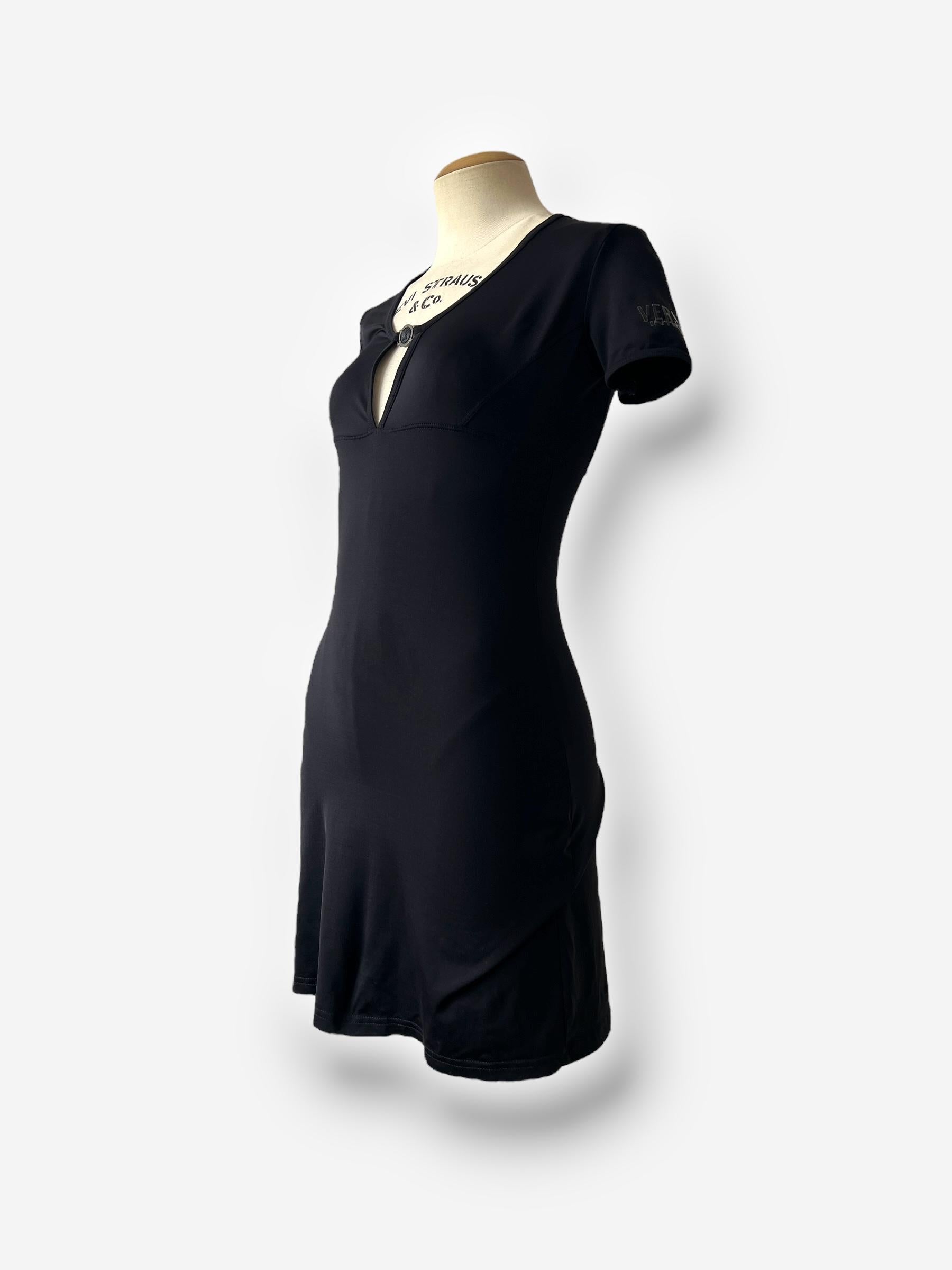 This ultra-flattering mini dress from Versace’s Intensive line captures the attitude of late 1990s Italian minimalism with a confident edge. Crafted in classic black with a sleek, body-skimming cut, the dress features a sculpted bust and a bold