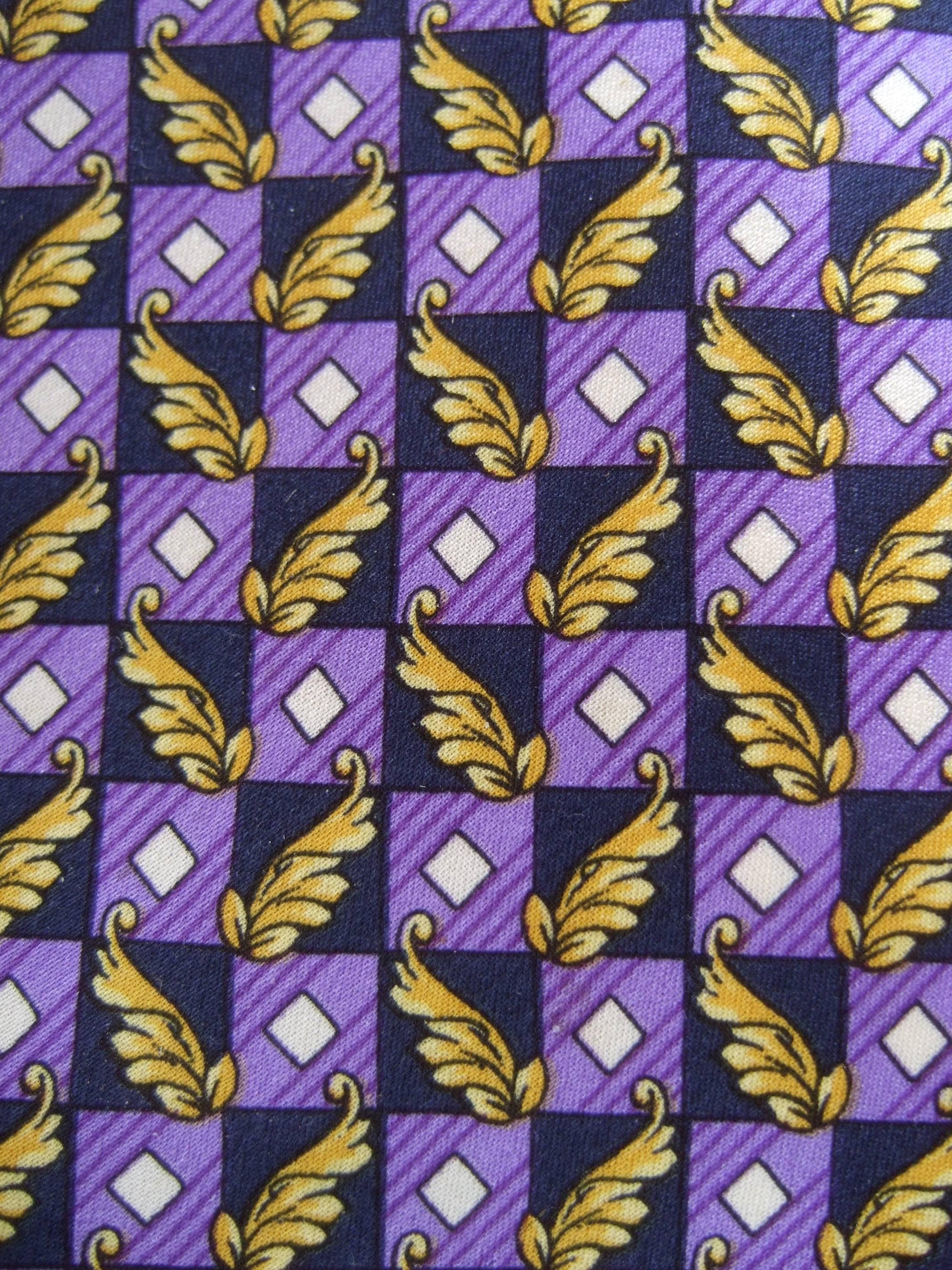 Versace Italian violet and gold graphic print silk necktie c 1990s
The stylish designer necktie is illustrated with violet color
block graphics juxtaposed with golden leaf foliage 

The geometric box design is contiguous on the front
Transitions