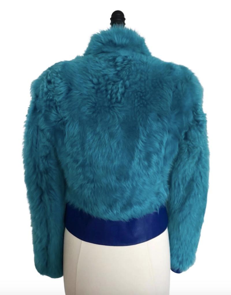1990’s Versace Jeans Couture Aqua Blue Faux Fur Jacket. Versace is known for its bold and eye-catching prints and colors, and this jacket is no exception. The faux fur adds a cozy & playful element that could elevate any look. Medusa details on