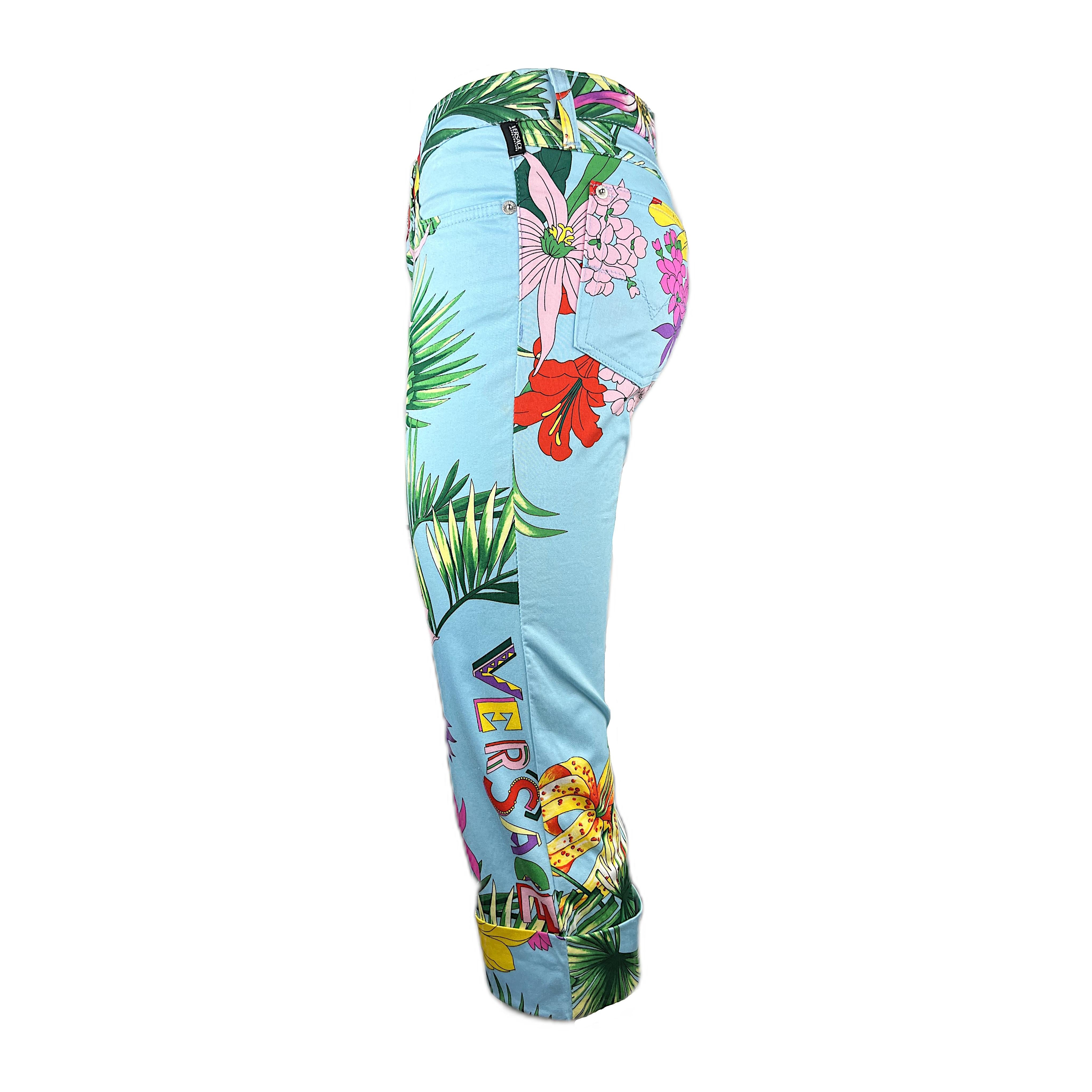 Wonderful capri pants labeled by Versace's casual brand, Versace Jeans Couture, featuring a tropical floral print on a cobalt background. These low-waist pants have V-shaped loops in the backside, 2 front pockets and 2 rear jeans-style pockets. All
