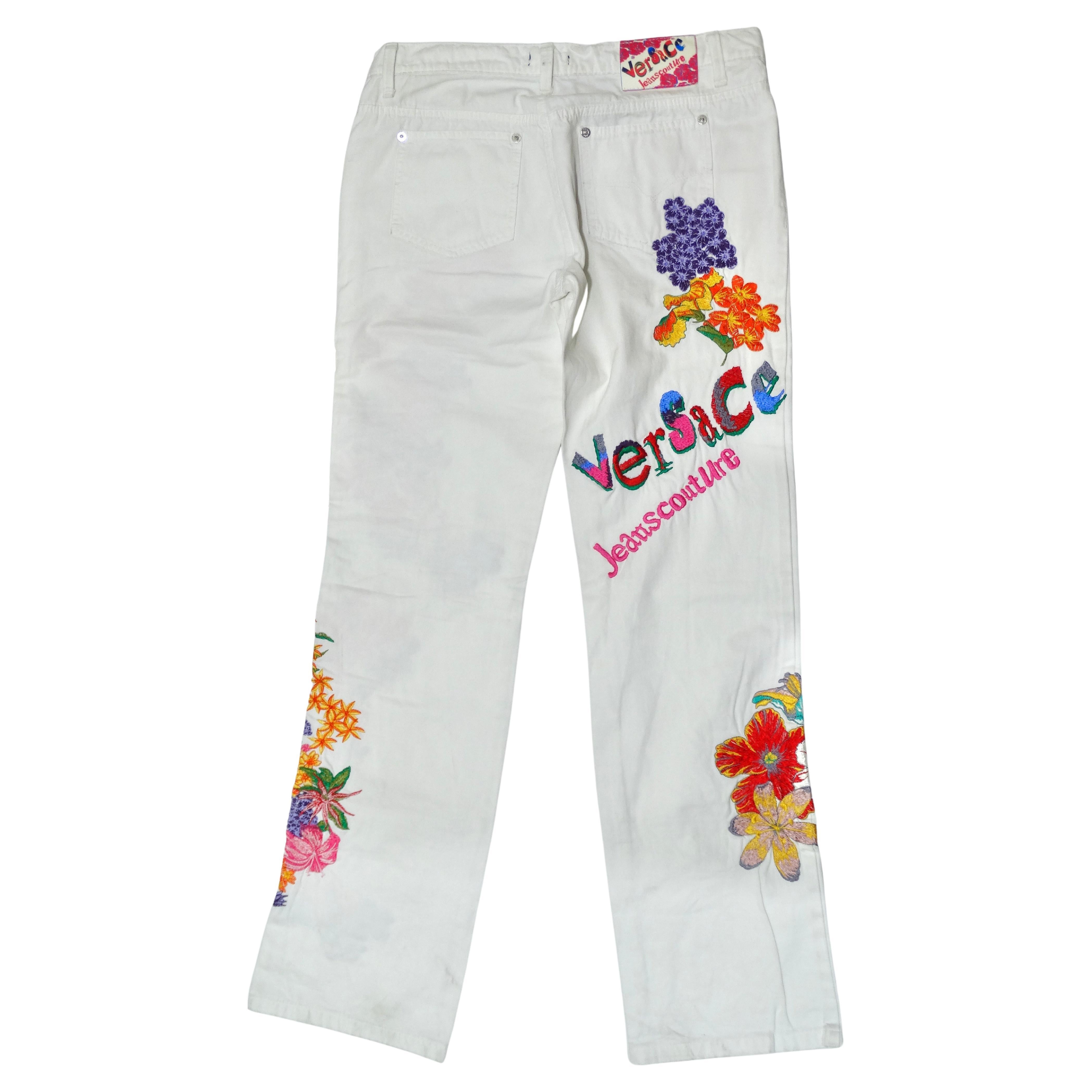 Don't miss out on the chance to get a beautifully detailed pair of Versace Jeans Couture. These feature intricate floral and letter embroidering in a beautiful color combo of purple, pink, and orange. The mix of delicate of flowers and bold