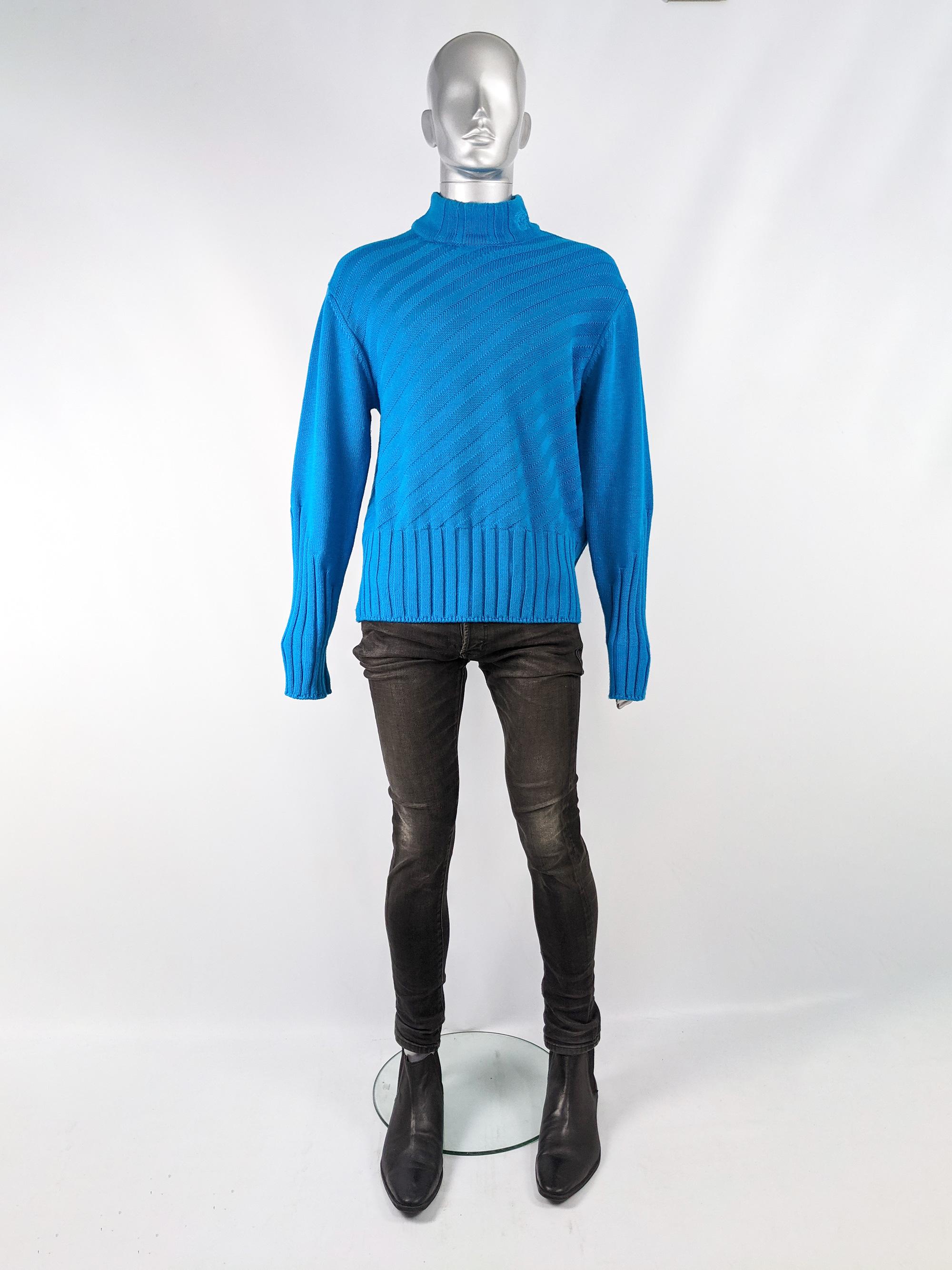 An amazing vintage man's Versace jeans Couture sweater from the 90s in a turquoise blue wool with contrasting ribbed knit techniques and extra long sleeves that can be turned up. The mock neck has Medusa logo embroidered on one side. Perfect for