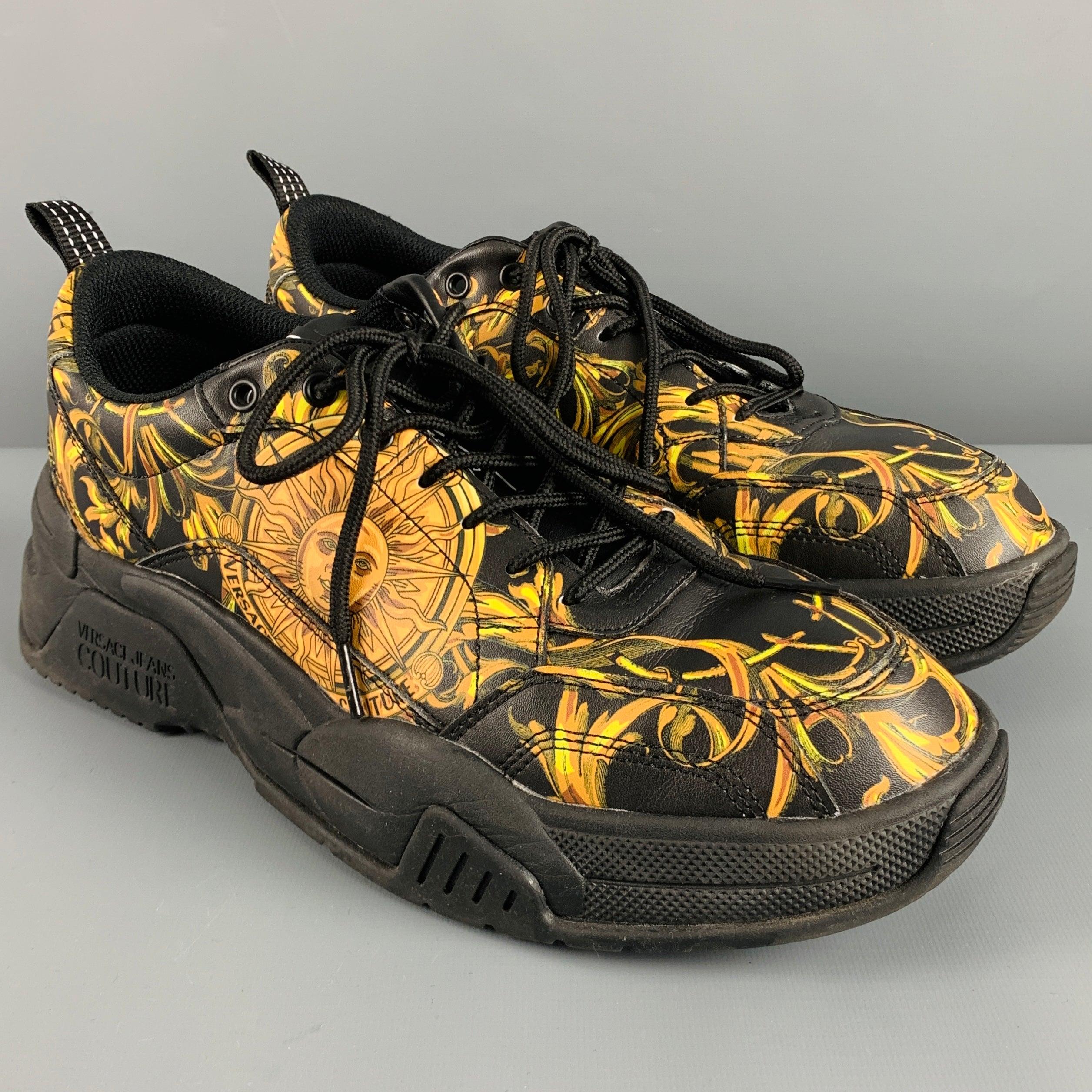 VERSACE JEANS COUTURE sneakers
in black leather fabric featuring gold baroque design with sun, chunky rubber sole, and lace-up closure. Comes with box.Very Good Pre-Owned Condition. Minor signs of wear. 

Marked:   EU 44Outsole: 12.25 x 5 inches 
 