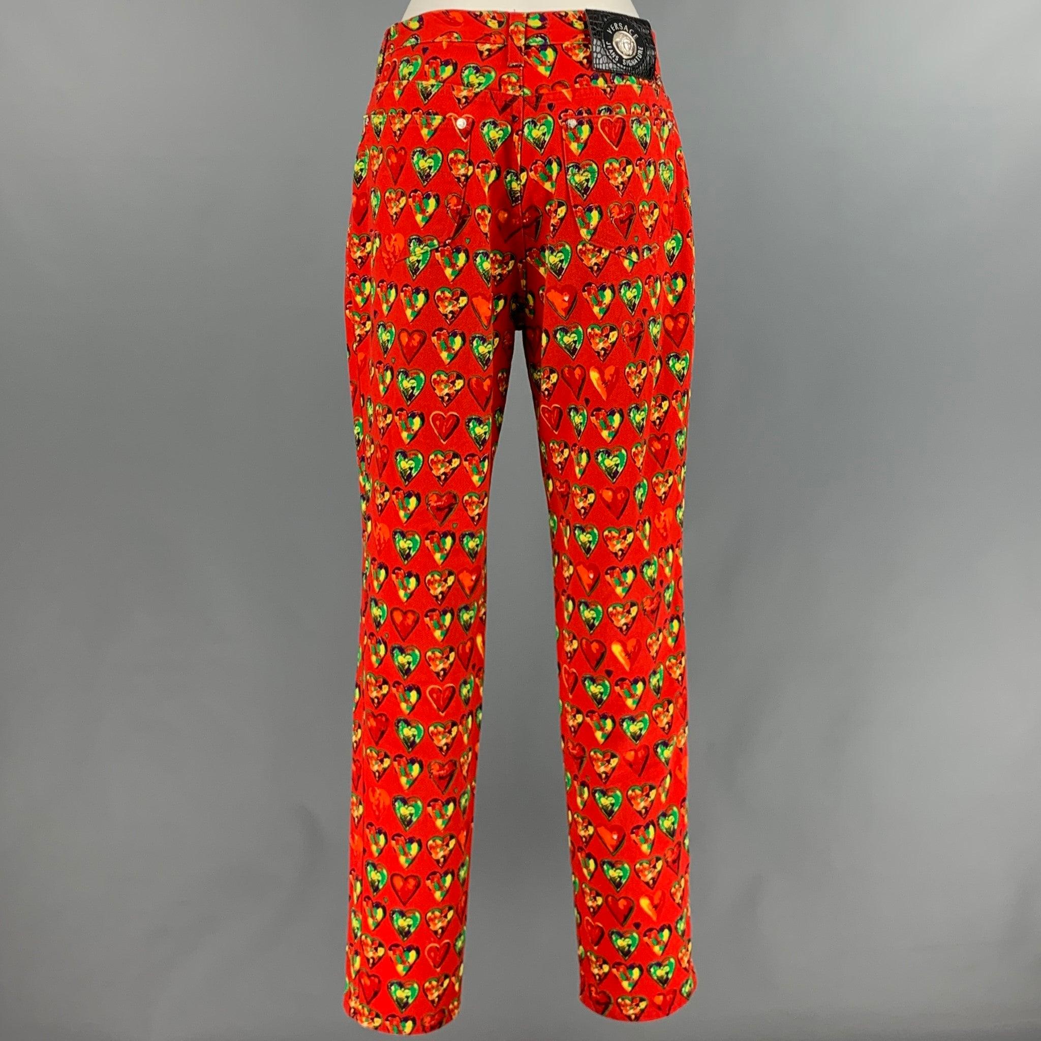 VERSACE JEANS COUTURE casual pants
in a red cotton fabric featuring a jean cut style, green and yellow hearts pattern, and a zip fly closure. Made in Italy.Excellent Pre-Owned Condition. 

Marked:   32/46 

Measurements: 
  Waist: 32 inches Rise: 10