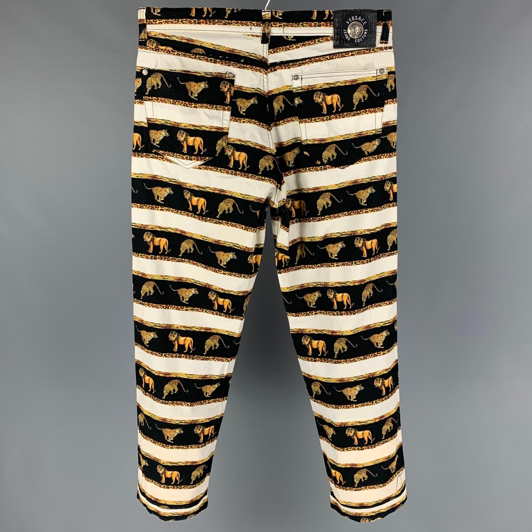 VERSACE JEANS COUTURE pants comes in a white & black cotton with a all over stripe animal print design featuring silver tone medusa head buttons, contrast stitching, and a button fly closure. 

Good Pre-Owned Condition. Moderate discoloration at