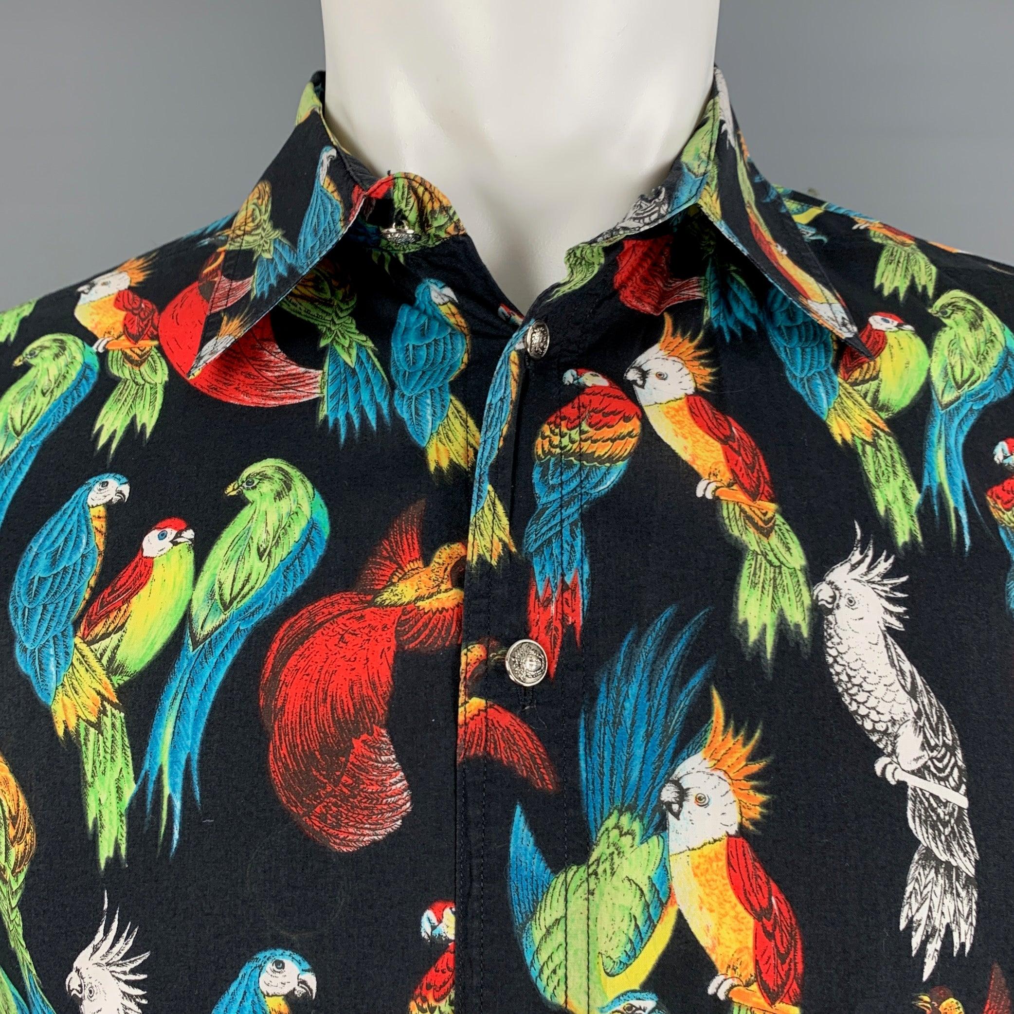 Vintage VERSACE JEANS COUTURE long sleeve shirt comes in a black and multi-color woven material featuring oversized style,
 silver tone medusa head buttons, tropical birds print motif, pointed collar, and a button up closure. Made in Italy. Very
