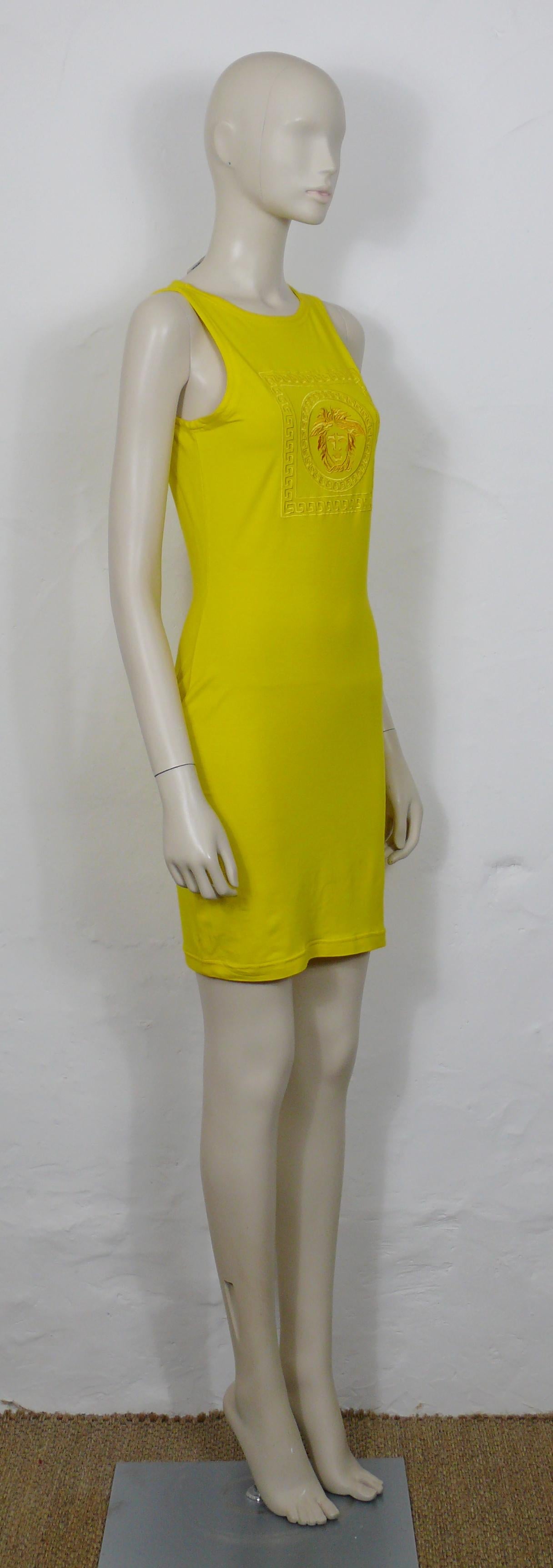 VERSACE JEANS COUTURE vintage yellow bodycon dress featuring an iconic embroidered MEDUSA.

Slips on.
Stretchy fabric.

Label reads VERSACE JEANS COUTURE.
Made in Italy.

Size tag reads : 32/46.
Please refer to measurements.

Composition tags read :