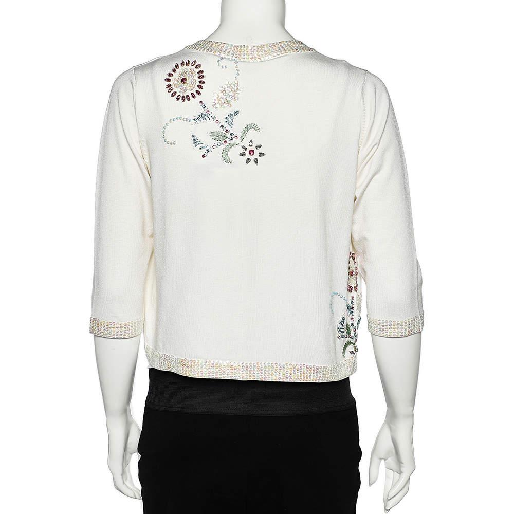 This shrug from Versace Jeans Couture is a delightful piece to own! It is tailored using white silk fabric and shows intricate sequin embellishments and an open-front detail. Look nothing but lovely as you wear this gorgeous shrug.

Includes: Price