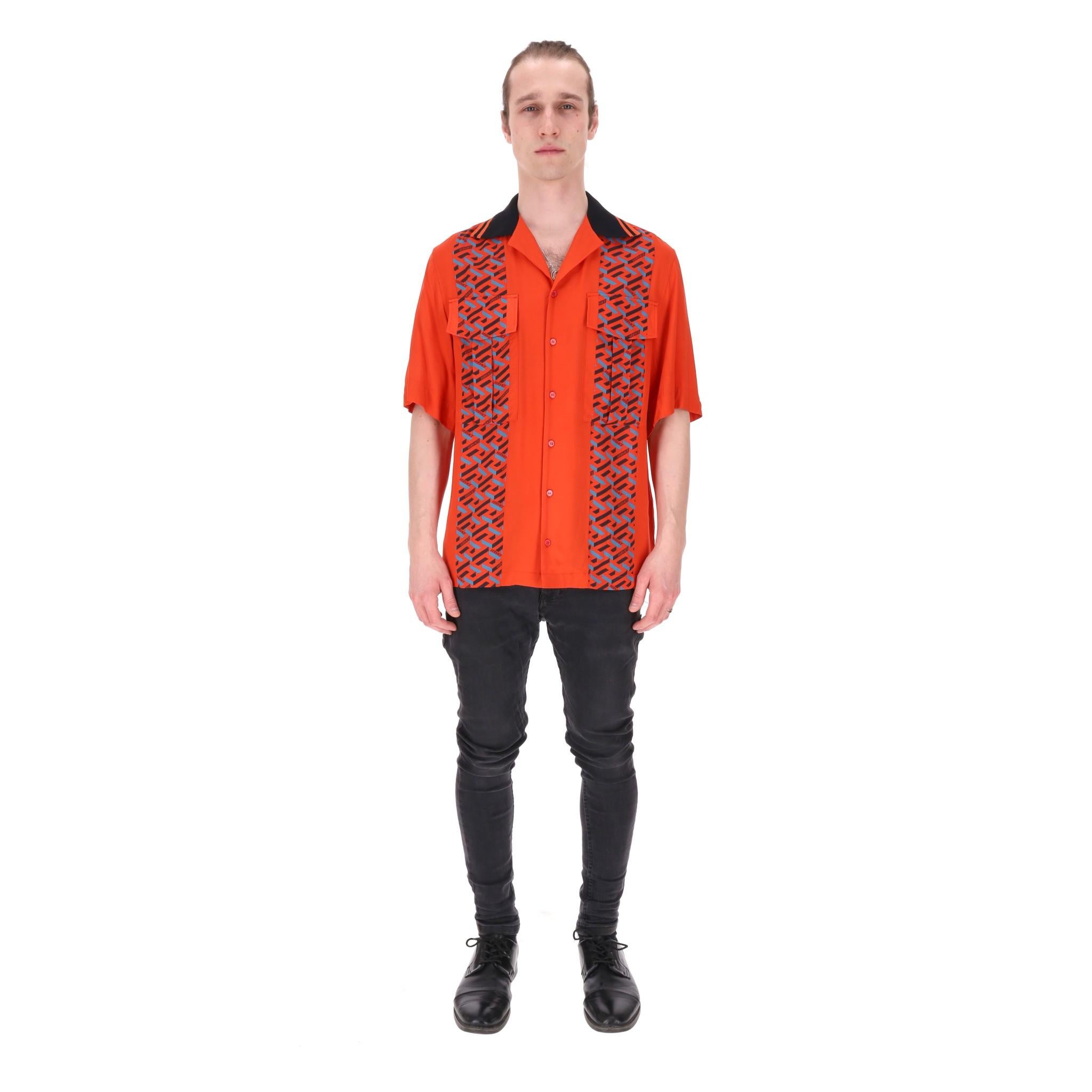Brand New - Versace La Greca Monogram Print Detail Shirt

Vibrant orange, relaxed-fit shirt designed with the label’s La Greca motif panels.

Featuring black trimmed collar, centre button closure, flap chest pockets and short sleeves. Rrp Approx.