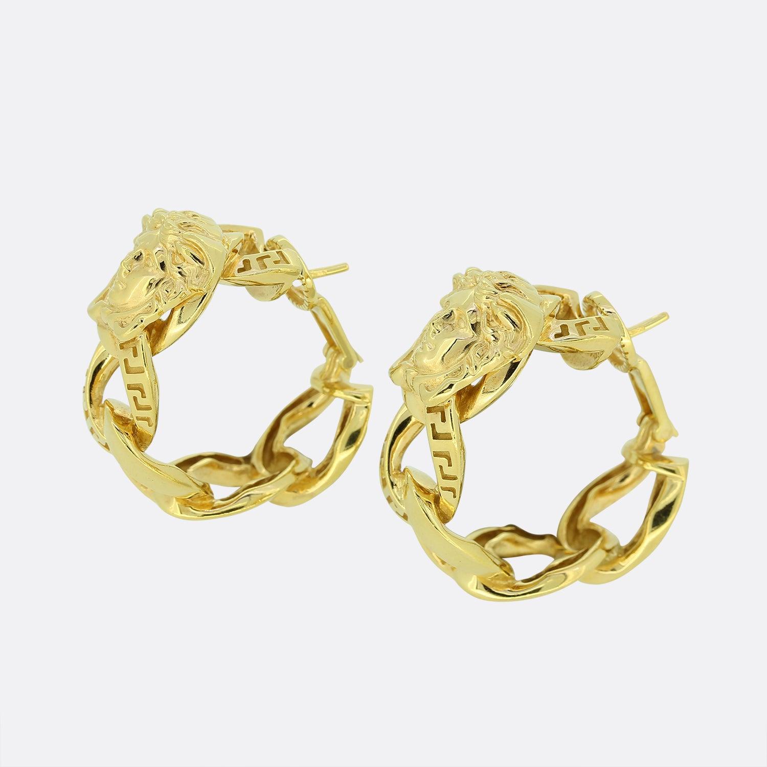 This is a fabulous pair of hooped 18ct yellow gold earrings from the luxury fashion designer Gianni Versace. Each earring showcases the infamous head of Medusa and iconic engraved Greca motif that Verace is famed for. The open woven design is