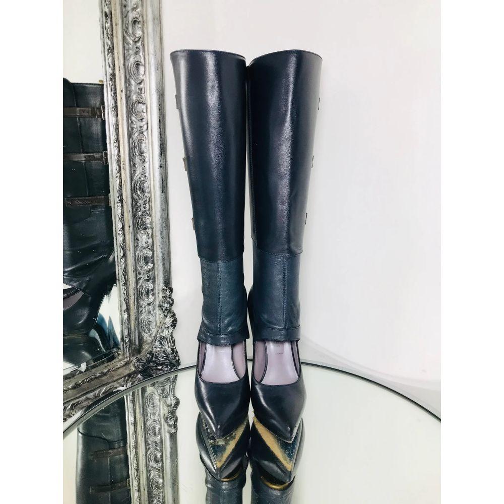Versace Leather Cut Out Boots 

Navy blue leather, cut out at feautre to the front and brown leather buckle detailing on the side. Knee high.

Additional information:
Size: 36
Composition: Leather
Condition: Very Good
Comes With: Boots Only 