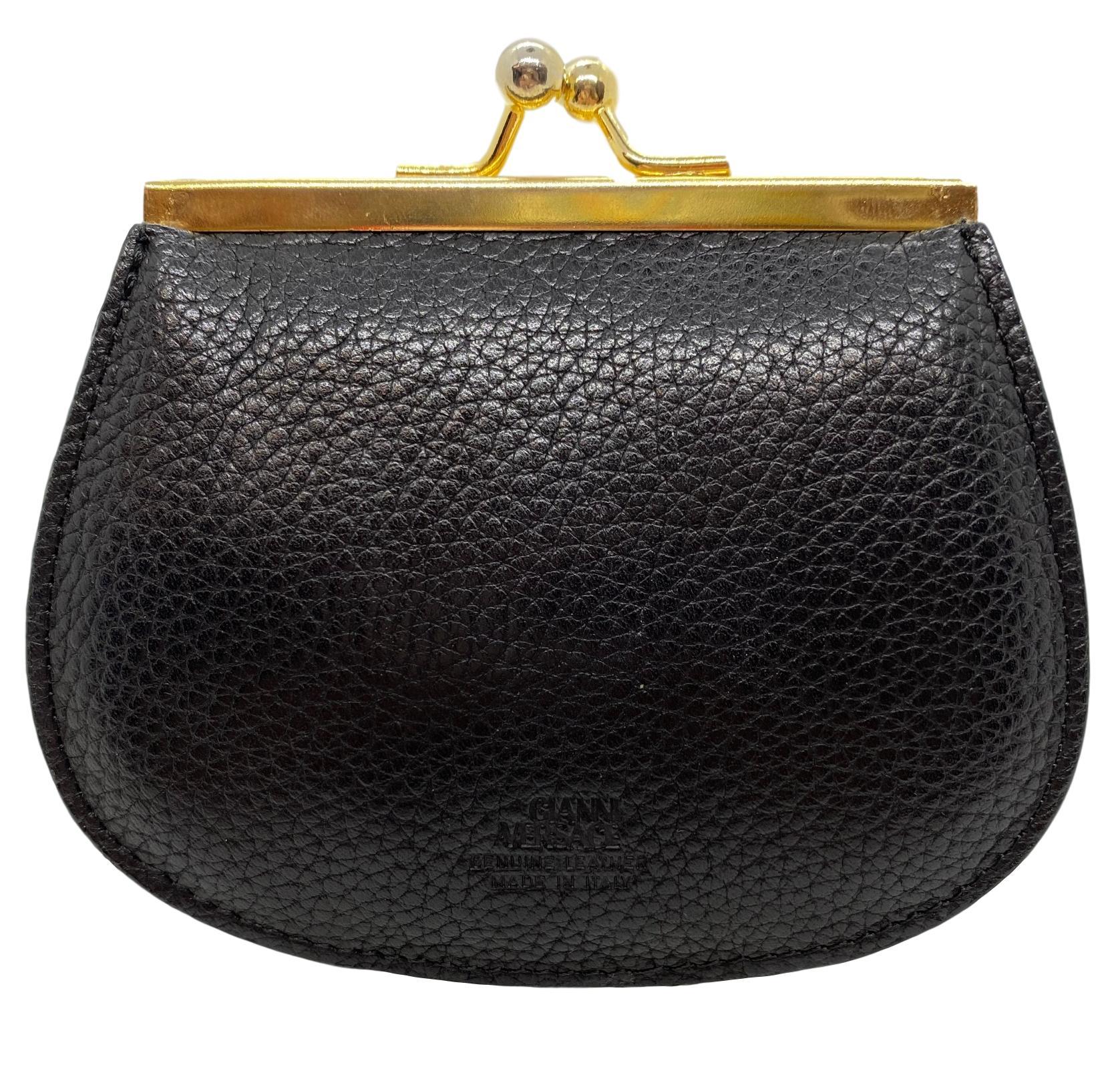 Versace Leather Medusa Coin Purse, Italy circa 1993. Hand crafted from calf-leather, this coin purse features a snap gold plated closure and two compartments for plenty of storage. In great vintage condition, this coin purse is the perfect addition