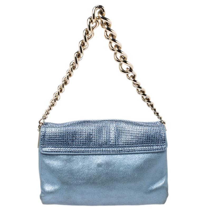 This Sultan shoulder bag from Versace is a fabulous piece. The bag comes in a luxurious light blue exterior made from crystal embellished shimmer leather and designed with the signature Medusa motif on the front, a gold-tone chain handle, and