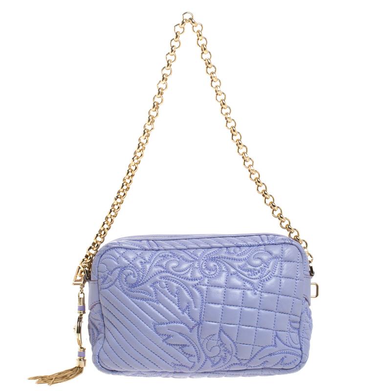 How gorgeous is this bag from Versace! Crafted from lilac leather and gold-tone hardware, it carries an outstanding embroidered design. It has a printed fabric interior secured by zippers and it is held by a single chain link. The tasselled-Medusa