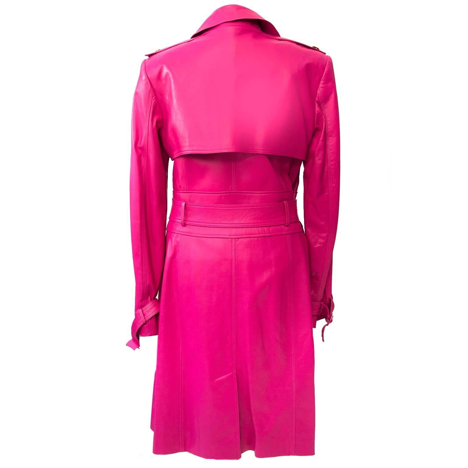 This super soft lambs leather coat was made by Versace in 2011.  
The trenchcoat features four gold metal Medusa buttons to fasten in front, a tie-wrap belt, epaulets and a storm flap on the back.
The interior is fully lined in pink medusa logo