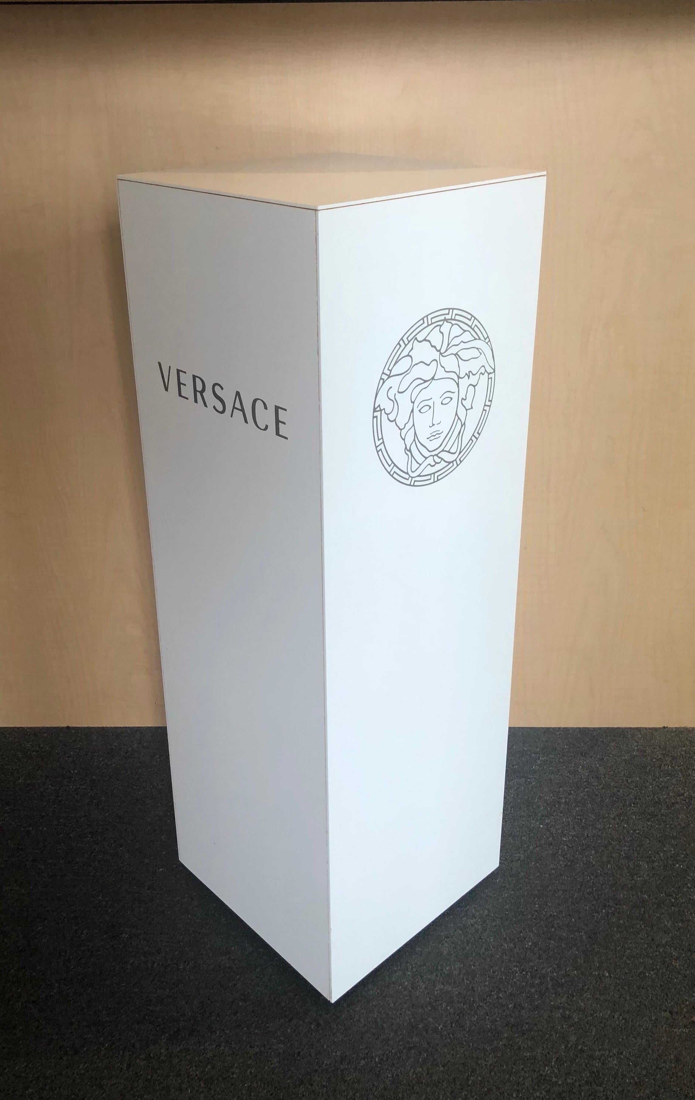 Super rare Versace logoed pedestal in white plastic laminate or melamine, circa 2000s. The piece was a former retail display at Saks Fifth Avenue in Los Angeles, CA and has either the 
