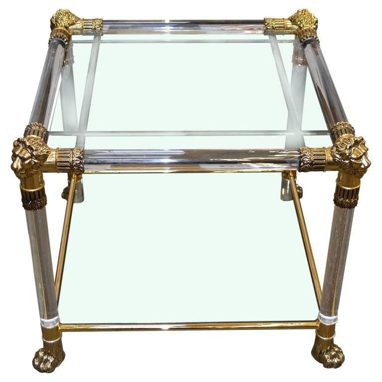 Versace Lucite and glass top side table with lion heads and feet of brass
The top glass piece has four circa 1 cm wide pound sign-shaped engraved lines. Lower glass piece for magazines has no decorations.

We offer $155 front door London delivery,