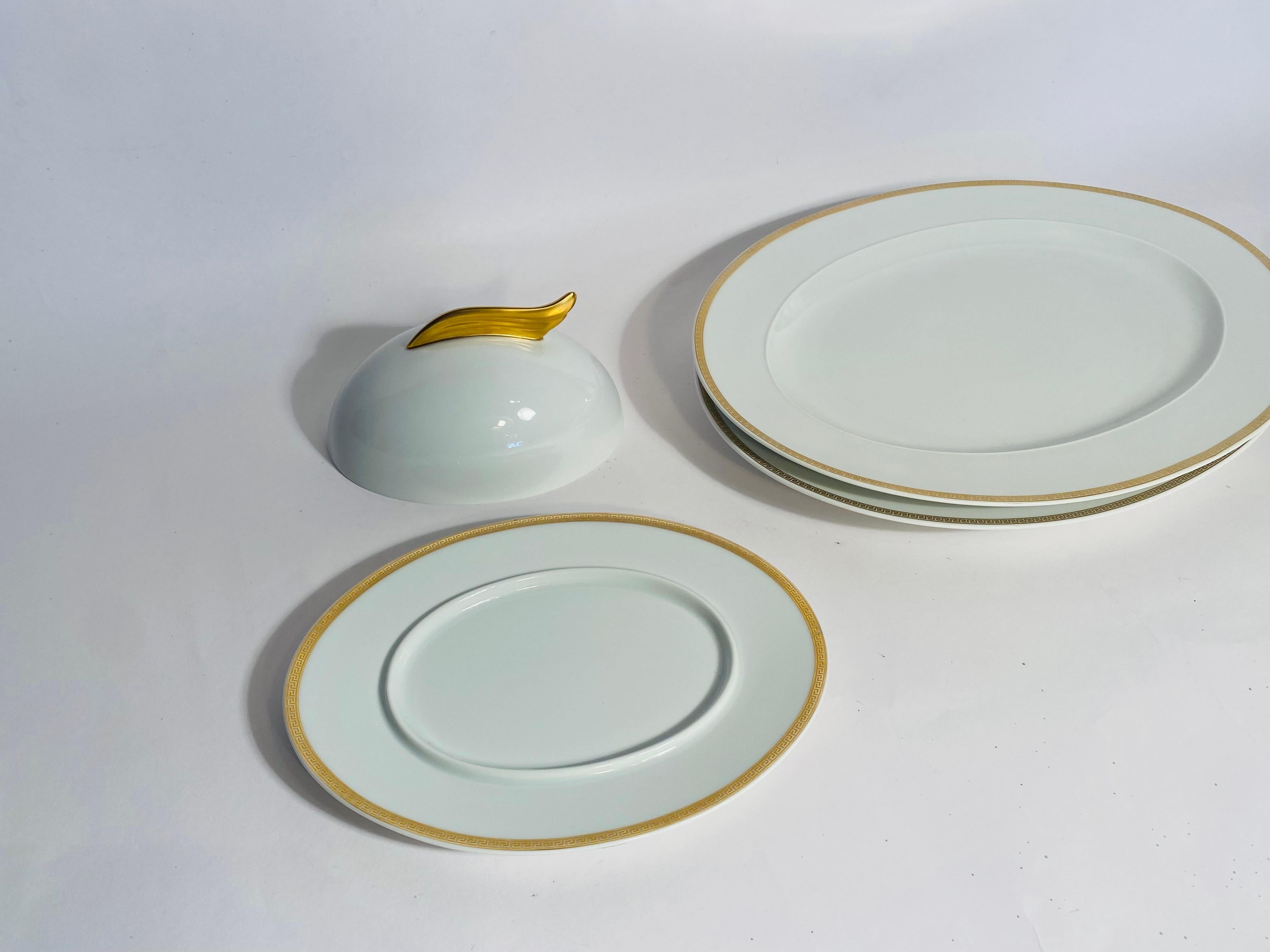 Versace Designed Crisp White Porcelain 3 Piece Serving Set with 2 Sixteen Inch Platters and One Covered Butter or Entre Dish measuring Nine and One Half Inches Long and Four and One Half Inches Wide. 
 The Medallion Meandre D'or pattern is