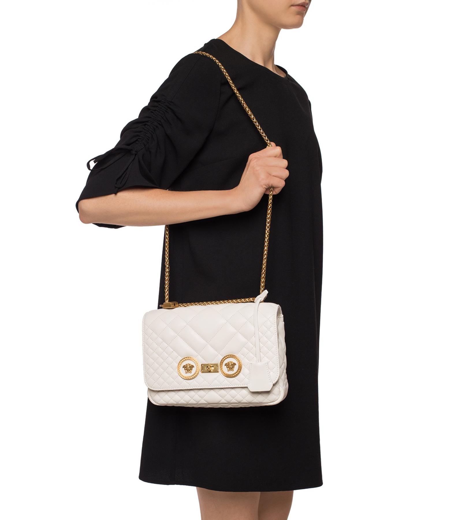 white handbag with gold chain