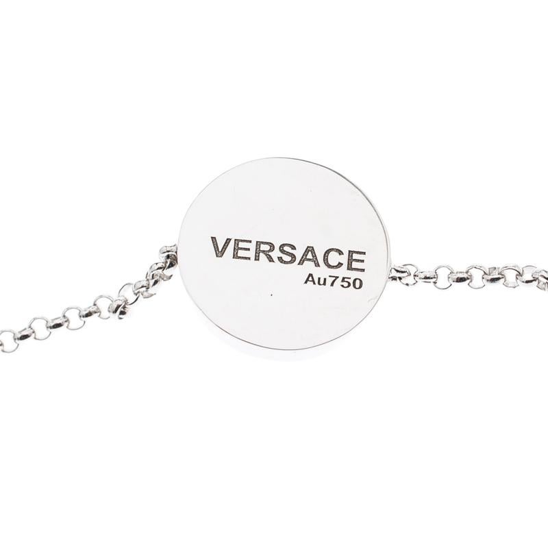 Artfully made from 18k white gold, this flawless bracelet by Versace can be your next prized possession. Featuring a gorgeous Medusa on the black inlay and a little diamond, the design has been finished with a lobster clasp. The piece is simple and