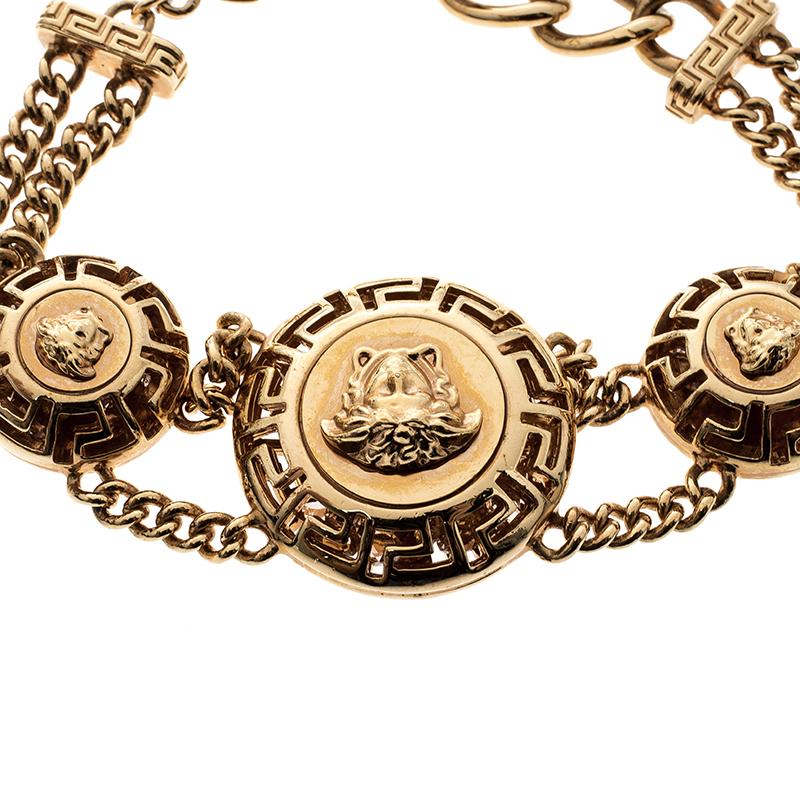 Wear this eye-catching creation from the house of Versace and get ready to garner compliments. Cast in a gold-tone chain link body, this bracelet features the iconic Medusa head motifs on it. It is secured with an adjustable lobster clasp closure