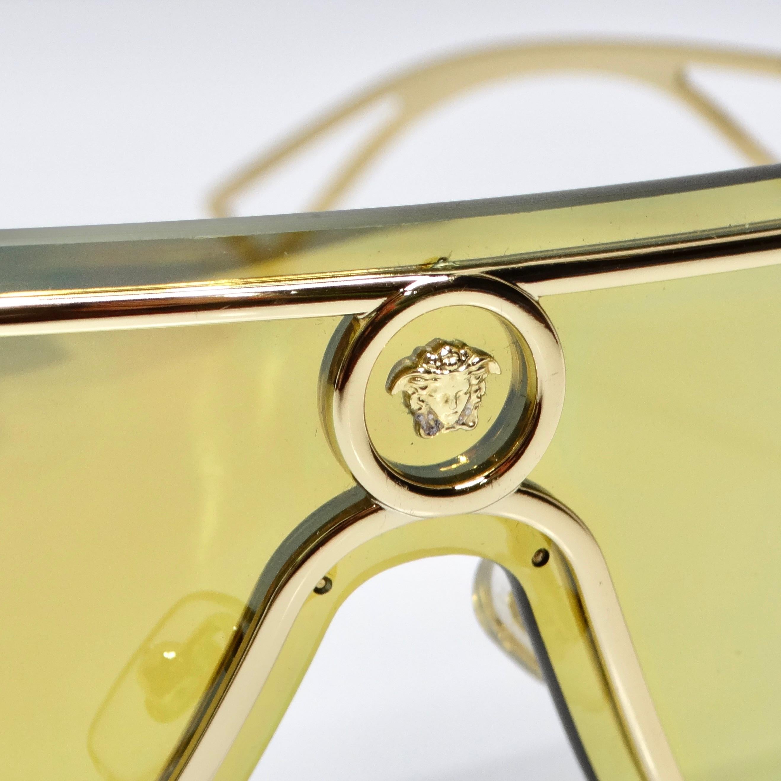 Introducing the Versace Medusa Gold Tone Mirrored Shield Sunglasses, a striking and luxurious accessory that exudes glamour and style. These incredible statement sunglasses are sure to turn heads with their bold design and impeccable